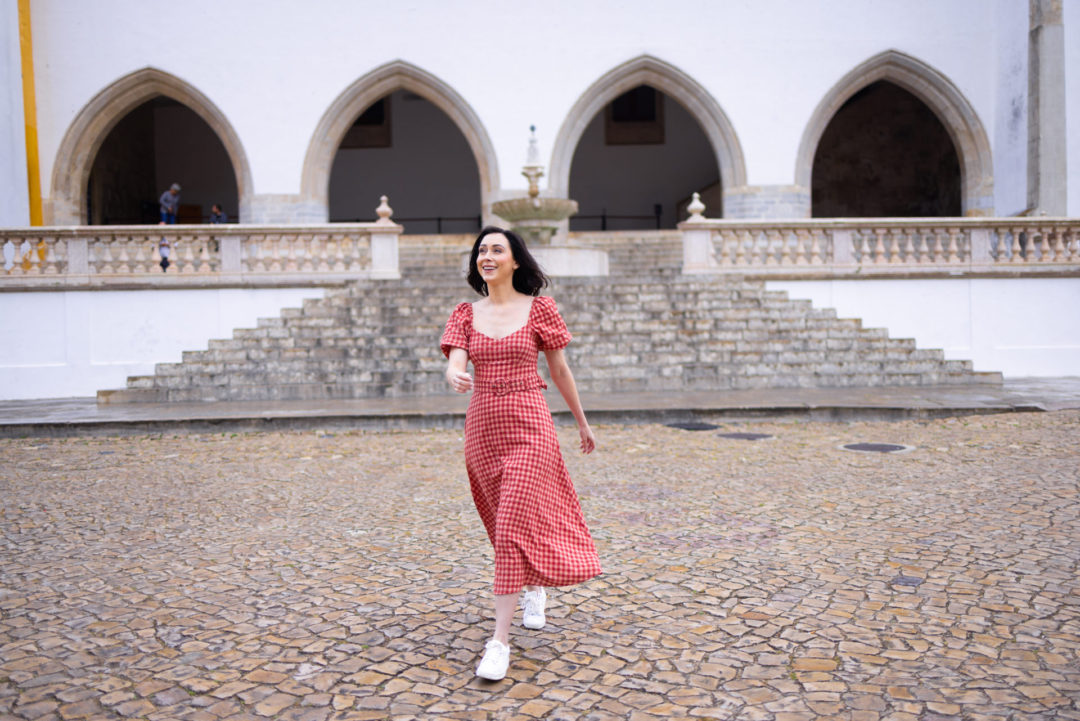 Travel Blogger Jordan Gassner walking in front of Sintra National Palace in Portugal