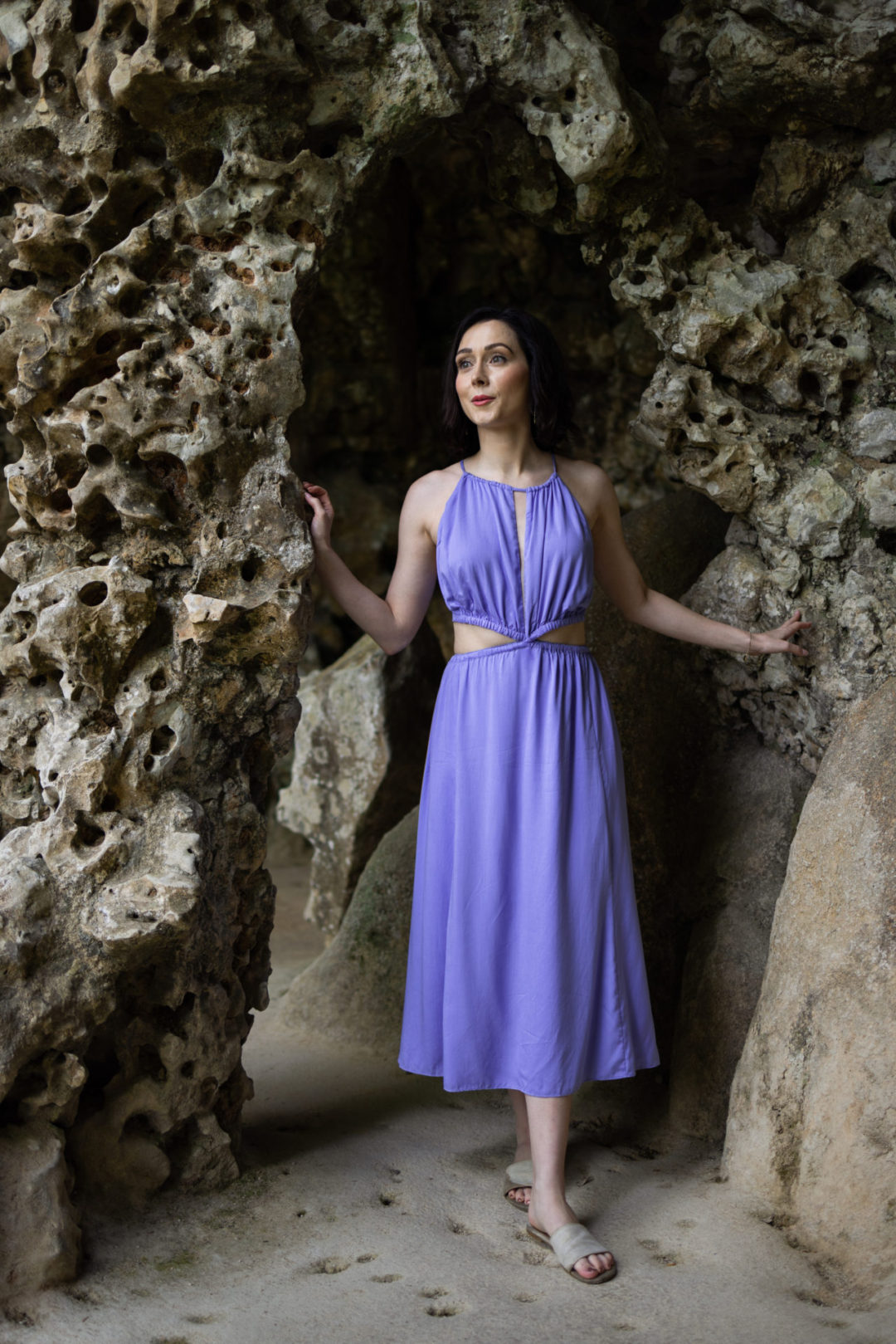 Travel Blogger Jordan Gassner wearing a lilac anna nata dress while traversing the caves at Quinta Da Regaleira in Sintra, Portugal