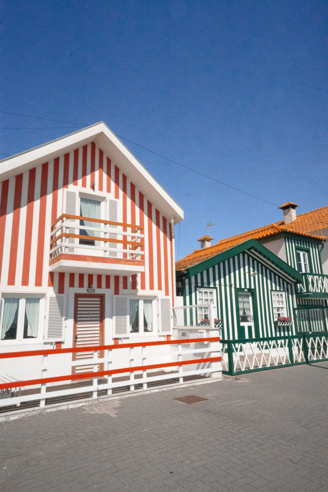 A set of red-orange and green striped houses in the seaside town of Costa Nova, Portugal
