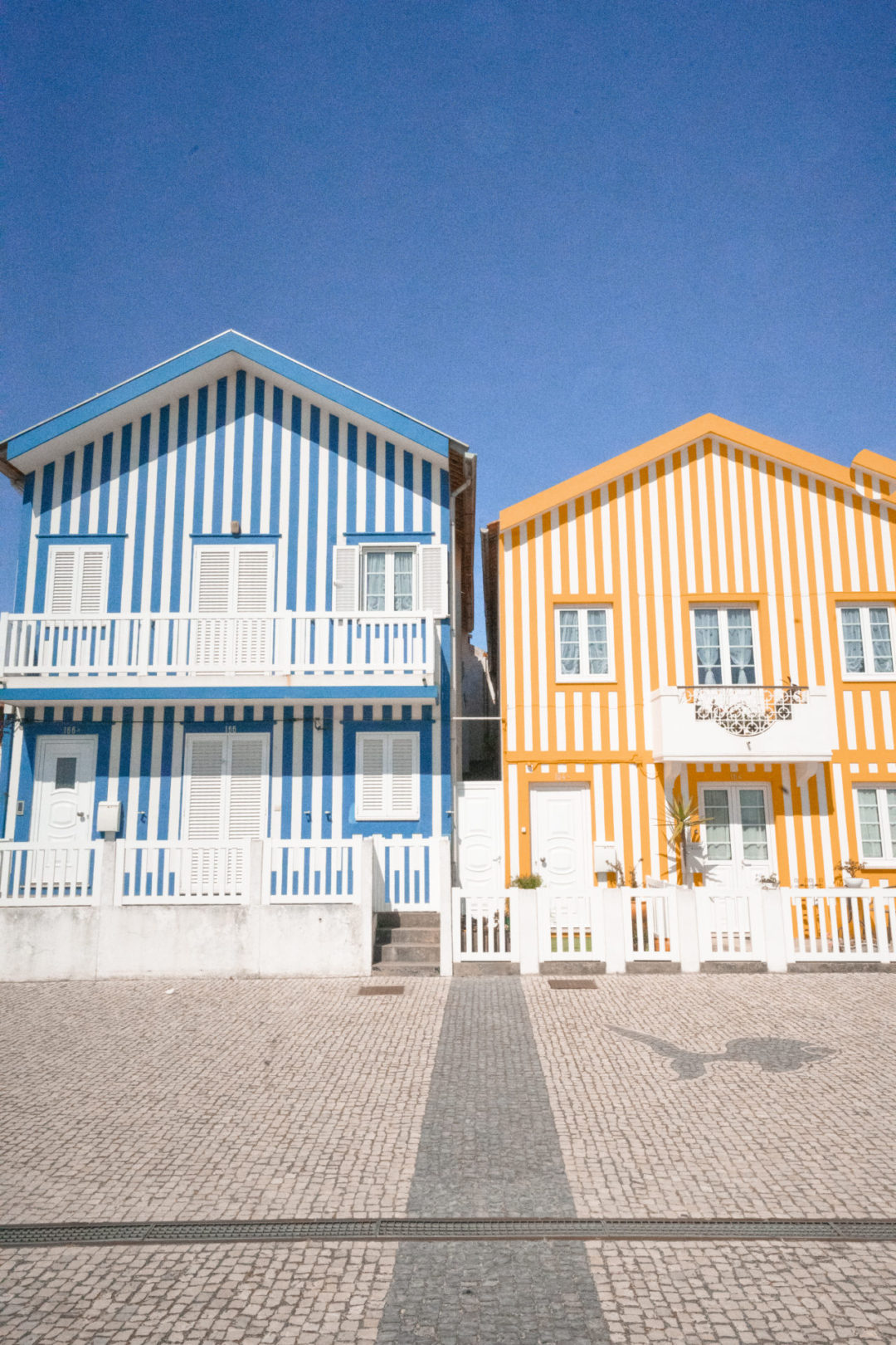 A set of blue and lemon striped houses in the seaside town of Costa Nova, Portugal