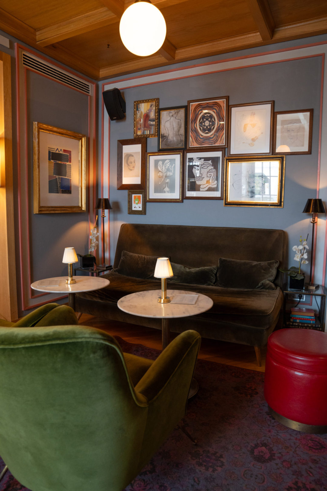 A brown and green sofa set and two marble tables in Browns Central Hotel in Lisbon, Portugal