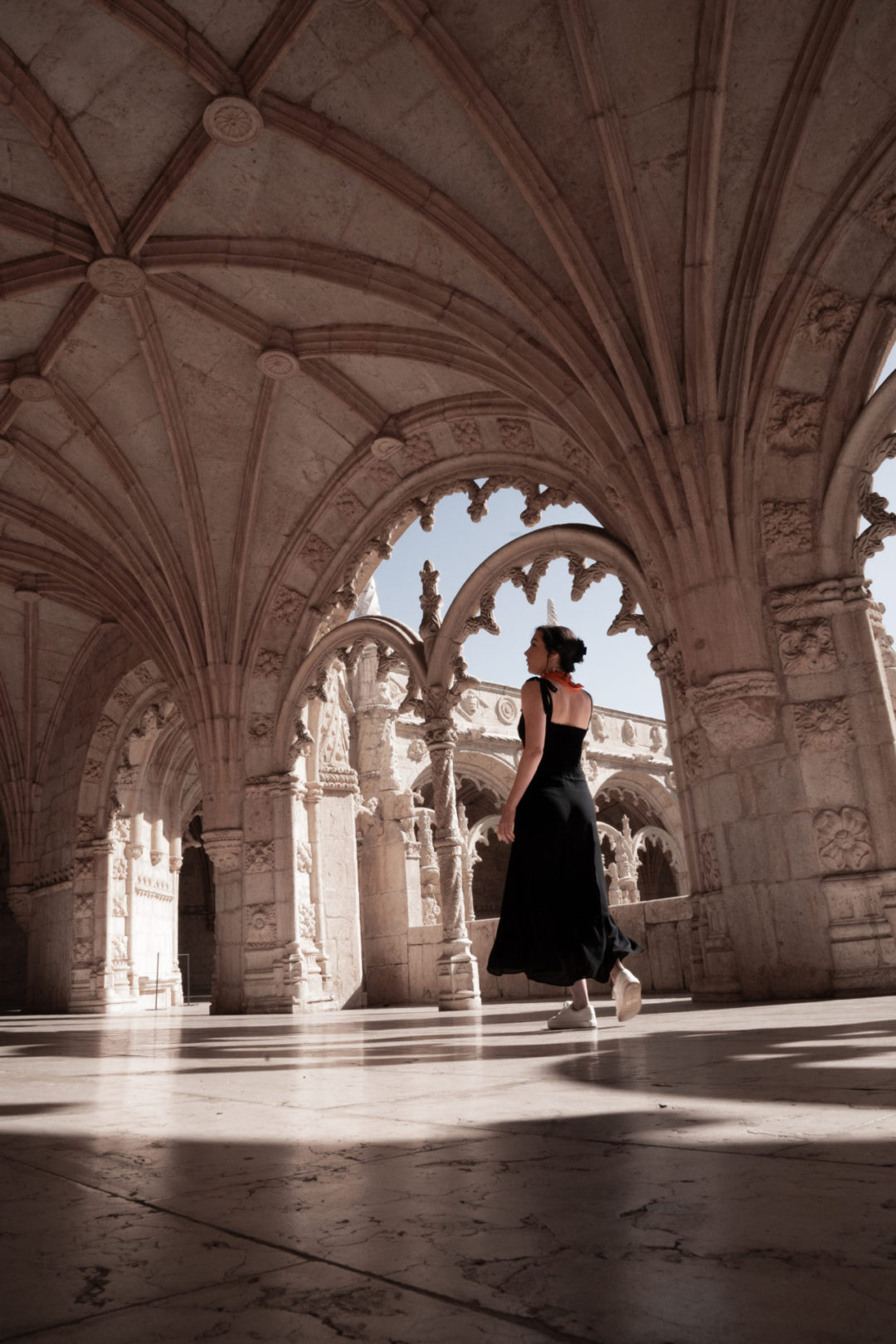 Lisbon Travel Guide: Jordan Gassner twirling in a black dress inside Jerónimos Monastery