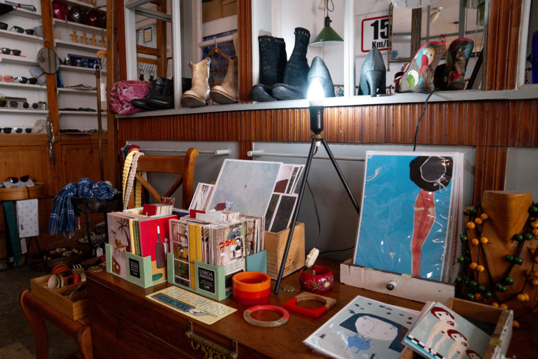A table with home goods, cards and jewelry inside of Wetani, a new + vintage clothing, accessories and home decor shop in Lisbon, Portugal