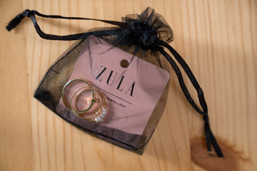 Lisbon Travel Guide: A black see-through bag with three gold rings and a Zula branded card from the Lisbon jewelry store, Zula