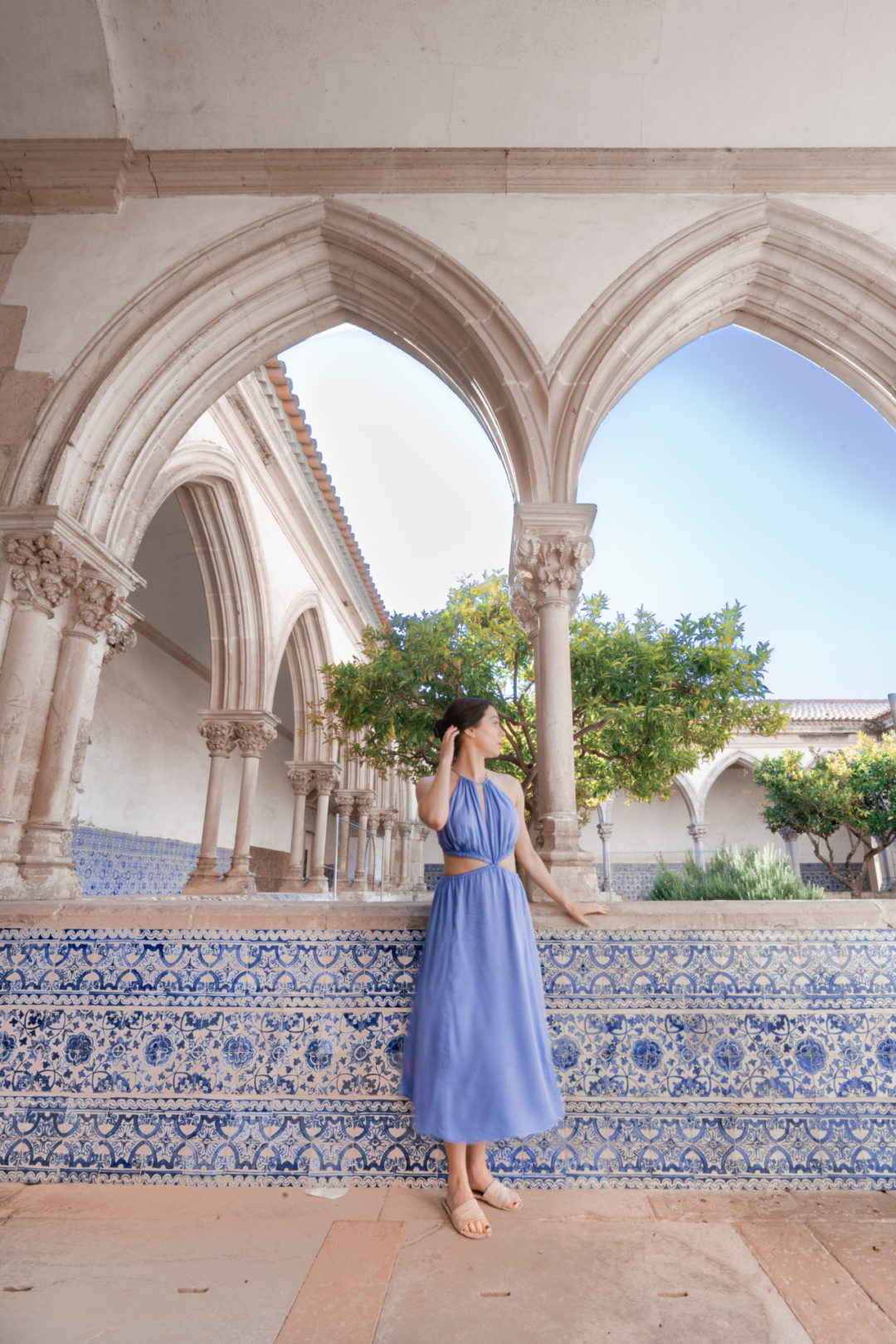 Travel Blogger Jordan Gassner looking out at a courtyard inside Convento de Cristo in Tomar, Portugal