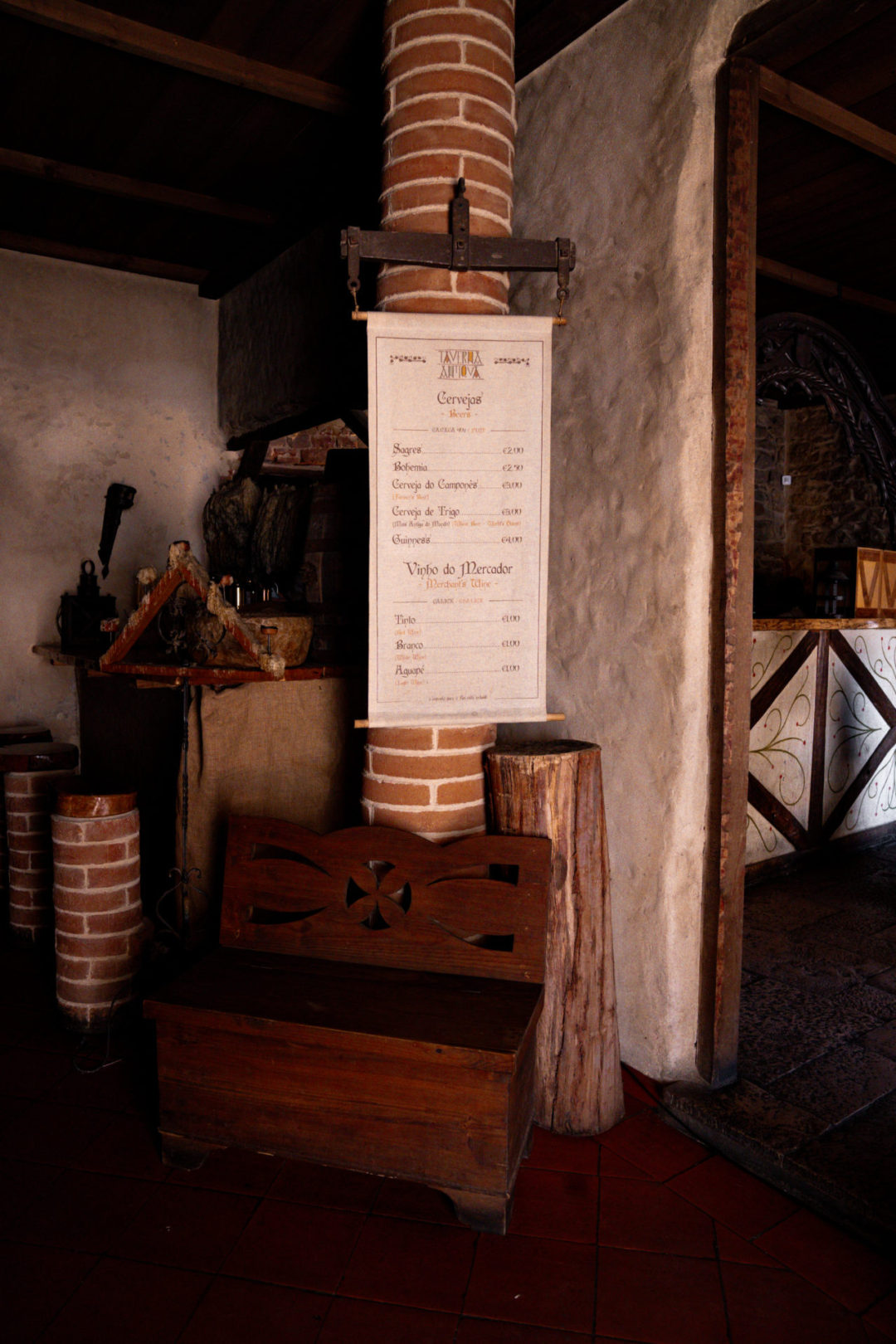 A bench near the entrance of Taverna Antica, a medieval restaurant in in Tomar, Portugal