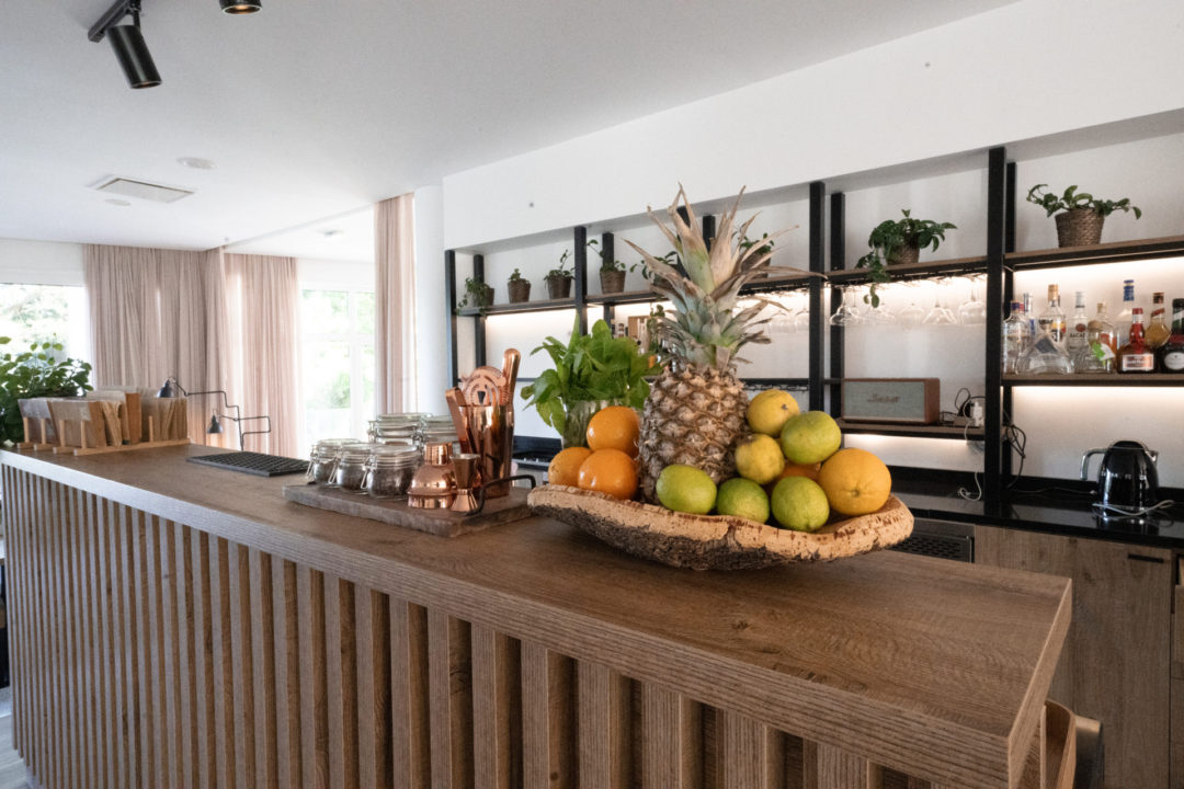 A tray of tropical fruit next to a tray of barware on top of a wood bar at Lamego Hotel and Life's 1926 Bar in the Douro Valley, Portugal