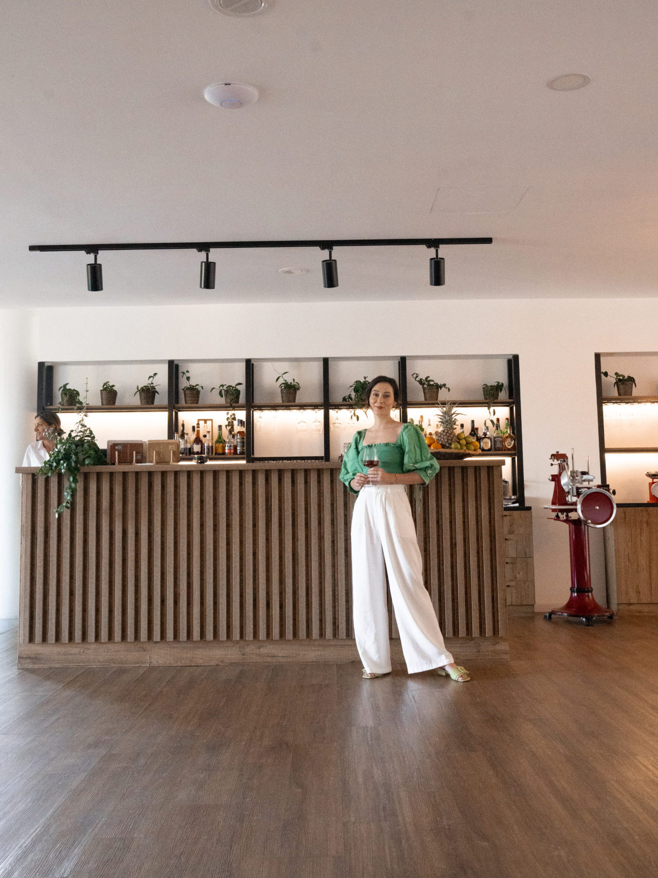 Travel Blogger Jordan Gassner holding a glss of wine inside 1926 Bar at Lamego Hotel & Life