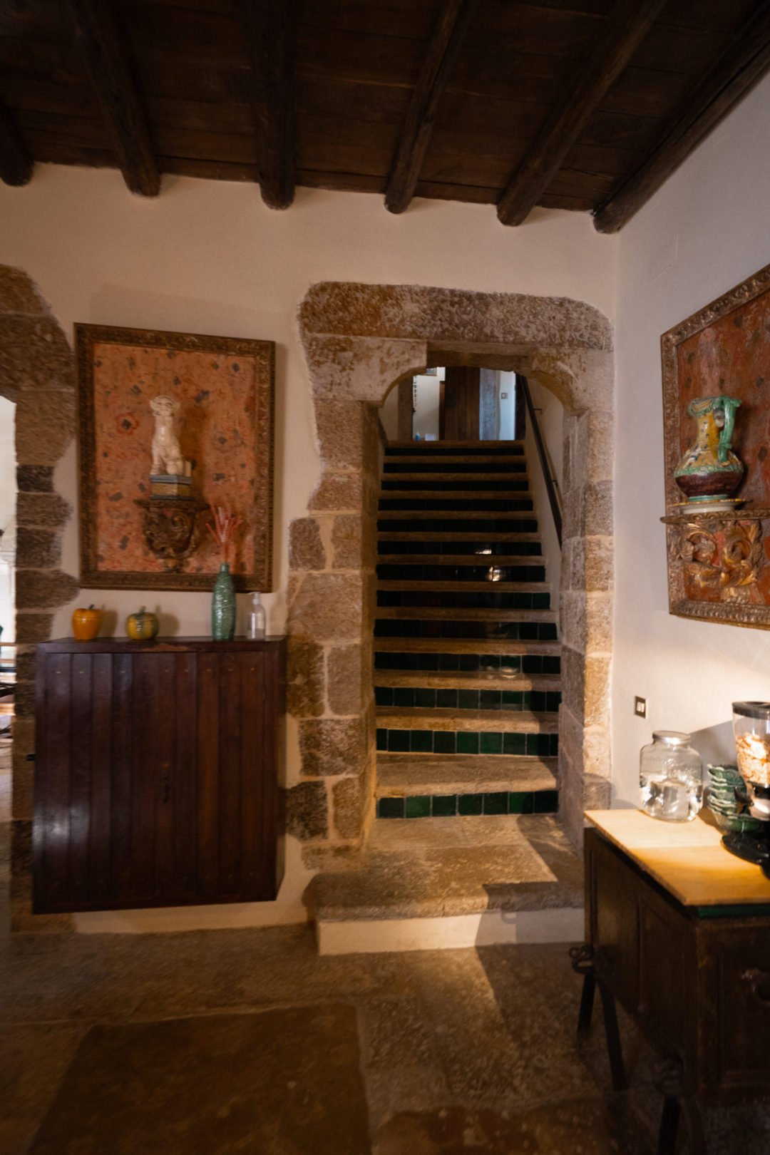 A set of stairs heading down to the kitchen and dining room inside Torre De Maneys, a hotel in Obidos, Portugal