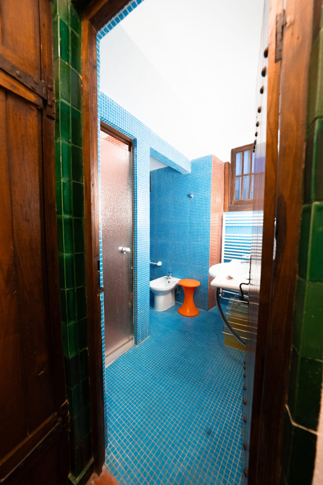 The doorway into the colorful bathroom inside the medieval tower hotel, Torre De Maneys in Obidos, Portugal