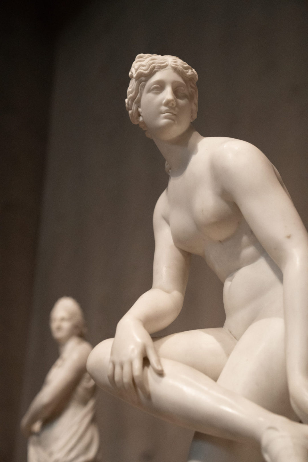 Two marble statues of Greek goddesses sitting inside The Getty Museum in Los Angeles