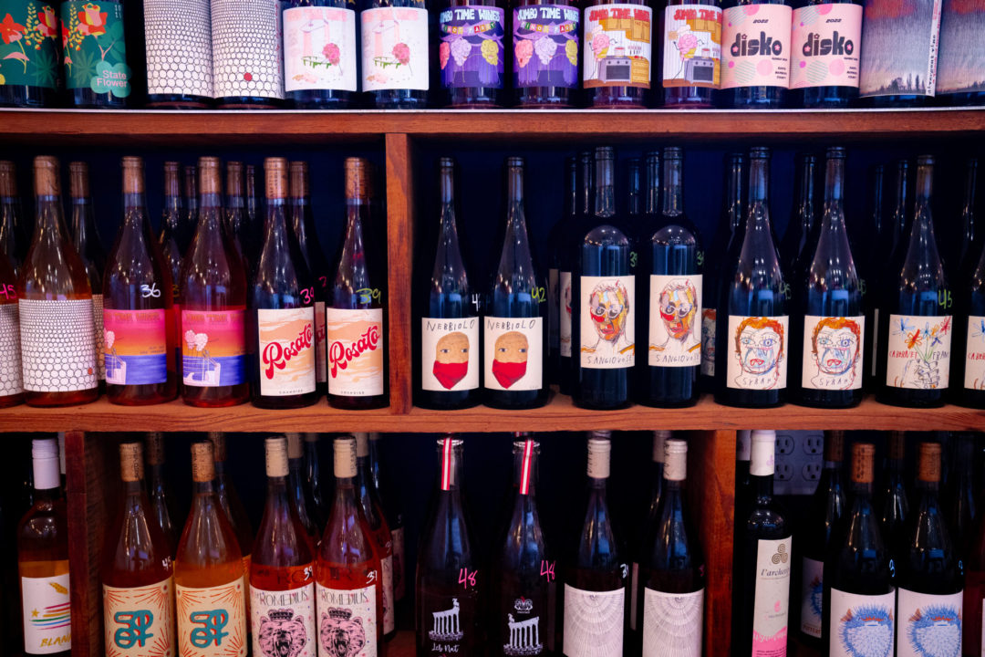 A shelf full of natural wine inside Endless Color natural wine shop in Topanga Canyon, California