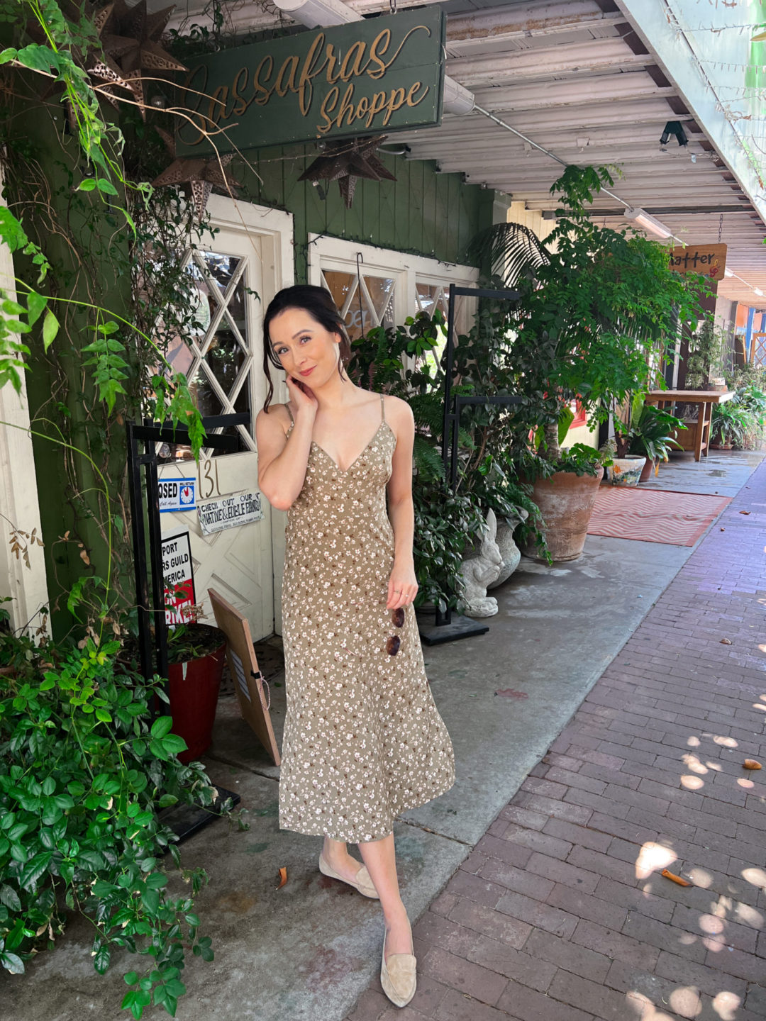 Travel Blogger Jordan Gassner shyly smiling at camera outside Sassafras Shoppe in Topanga Canyon, California