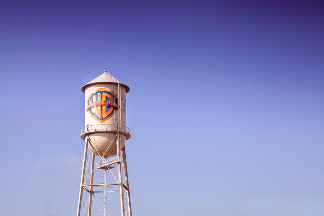 The historic Warner Bros Studio Water Tower in Burbank, California under a pink-purple sky
