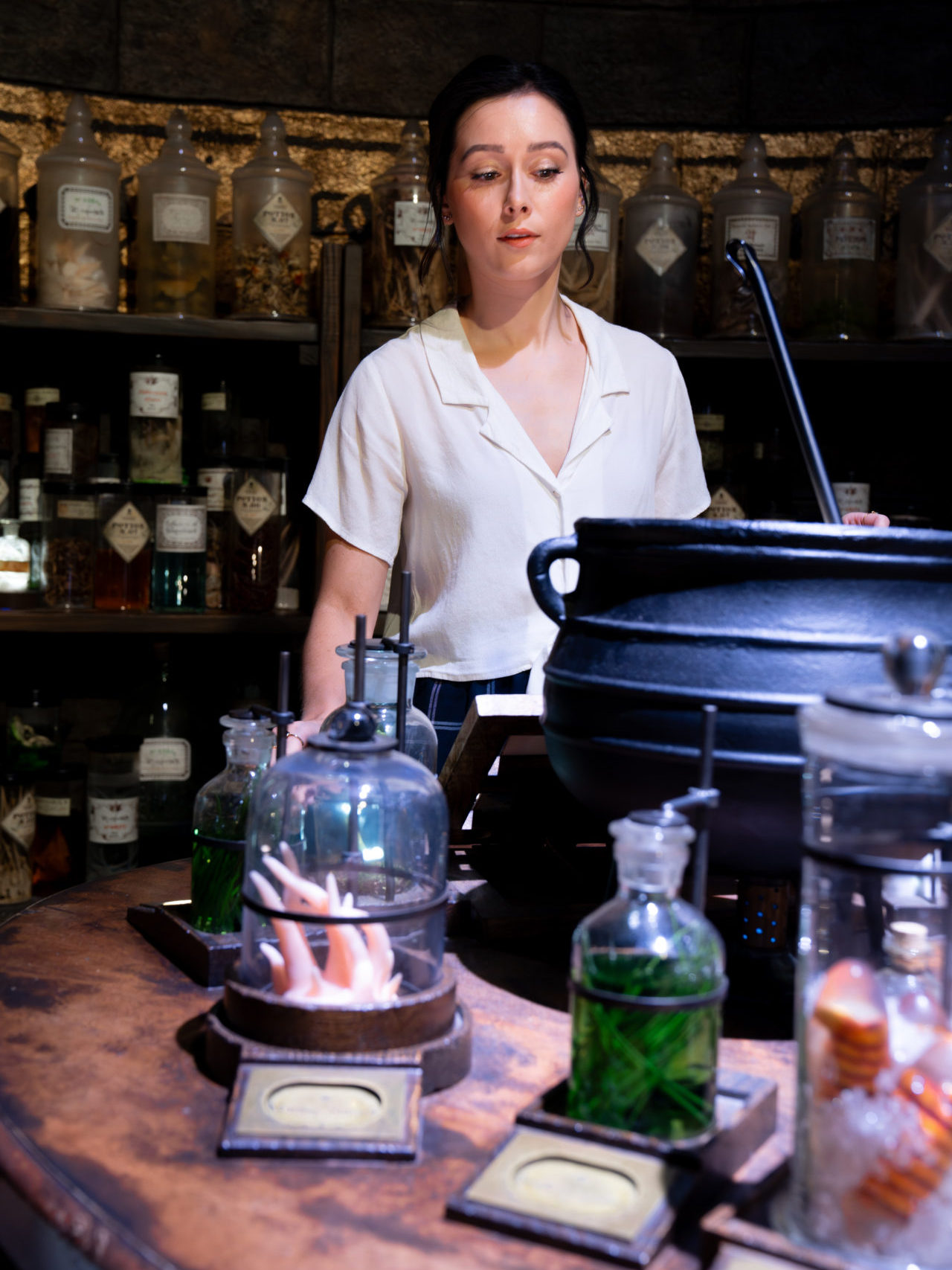 Travel Blogger Jordan Gassner mixing a "potion" on an interactive Harry Potter set while on the Warner Bros. Studio Tour in Burbank, California, USA