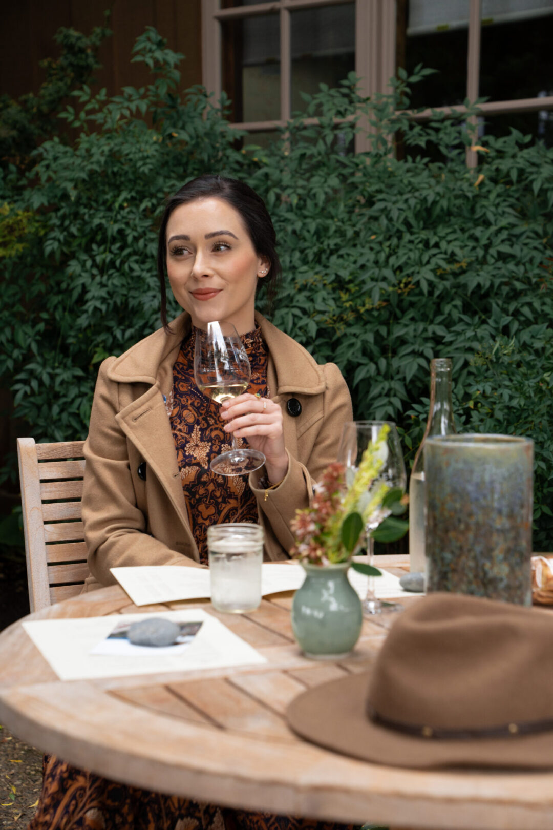 Travel Blogger Jordan Gassner smiling while holding a glass of white wine at Handley Cellars in Anderson Valley, California