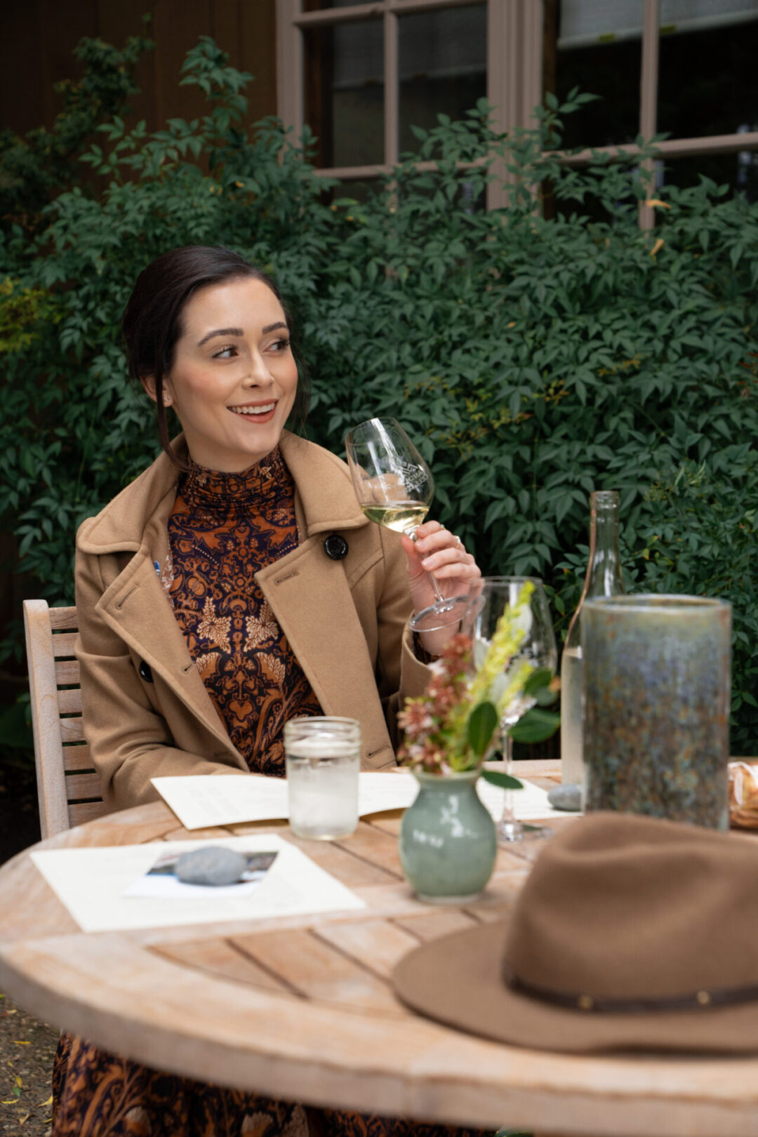 Travel Blogger Jordan Gassner laughing while holding a glass of white wine at Handley Cellars in Anderson Valley, California