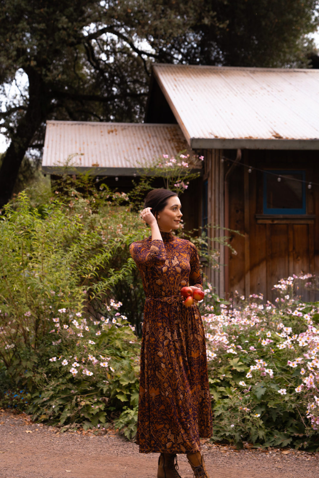 Travel Blogger Jordan Gassner moving her hair out of her face while exploring Philo Apple Farm in Mendocino County, California
