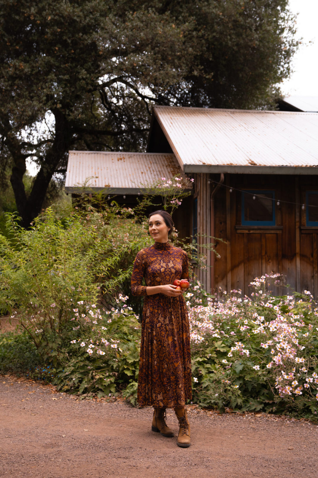 Travel Blogger Jordan Gassner looking over her shoulder and smiling at the Philo Apple Farm in Mendocino County's Anderson Valley