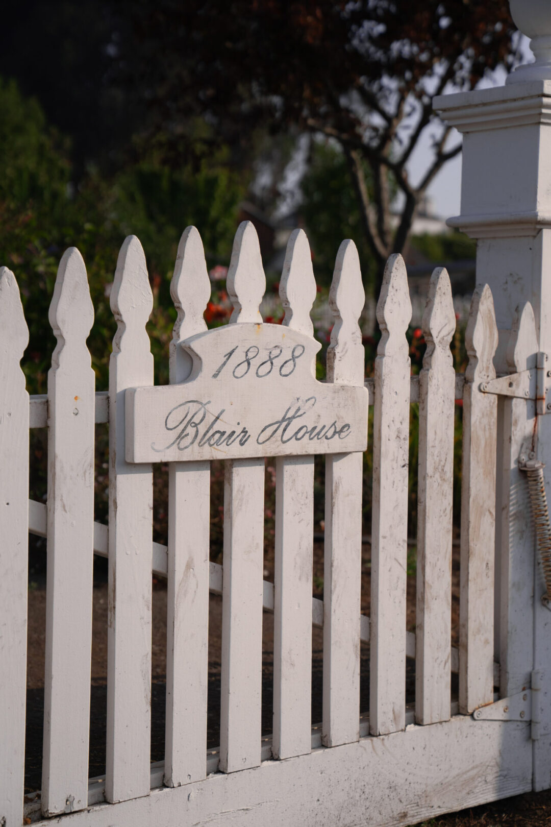 A white wooden gate labeled "Blair House"