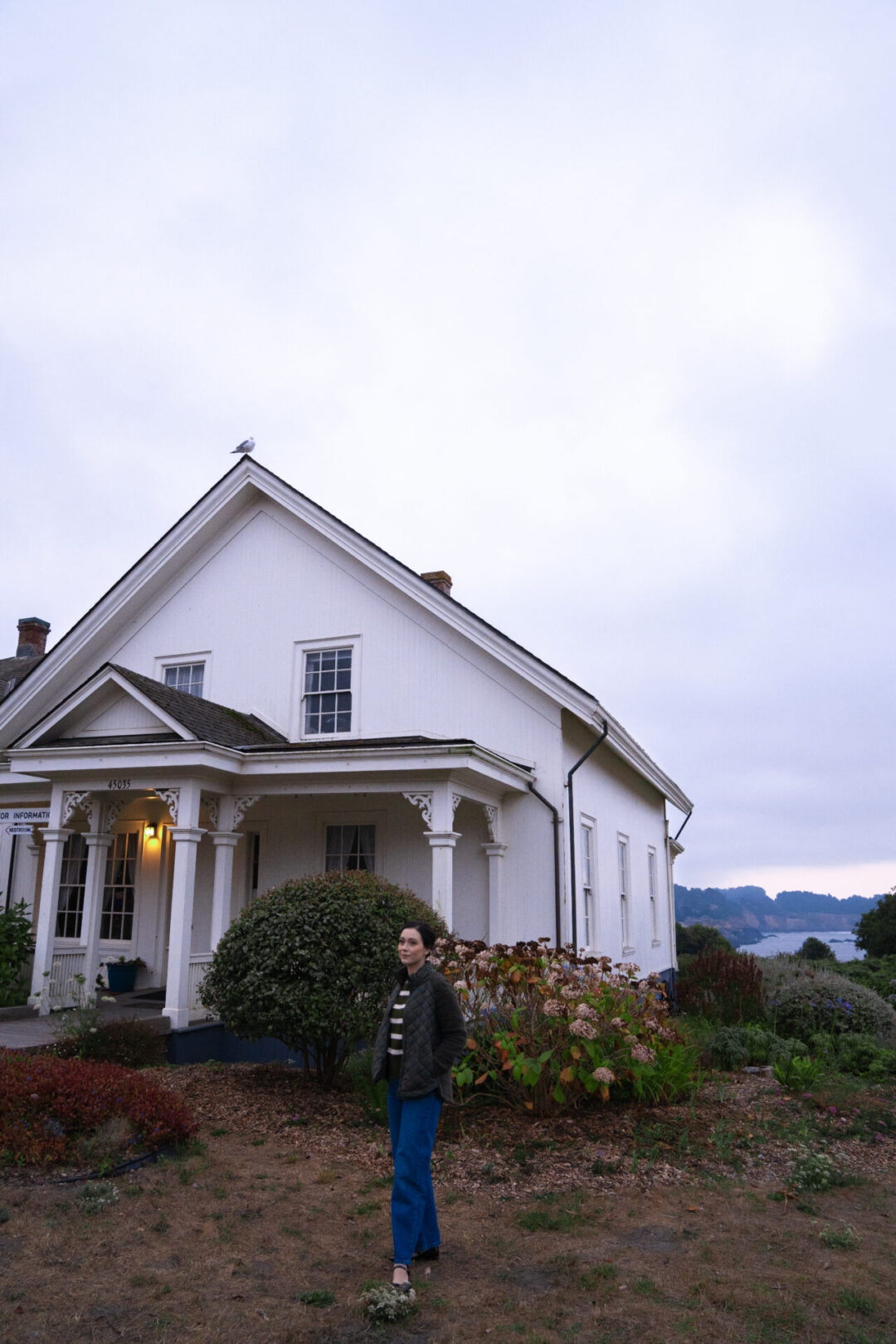 Travel Blogger Jordan Gassner bundled up before sunrise at the historic Ford House in Mendocino, California