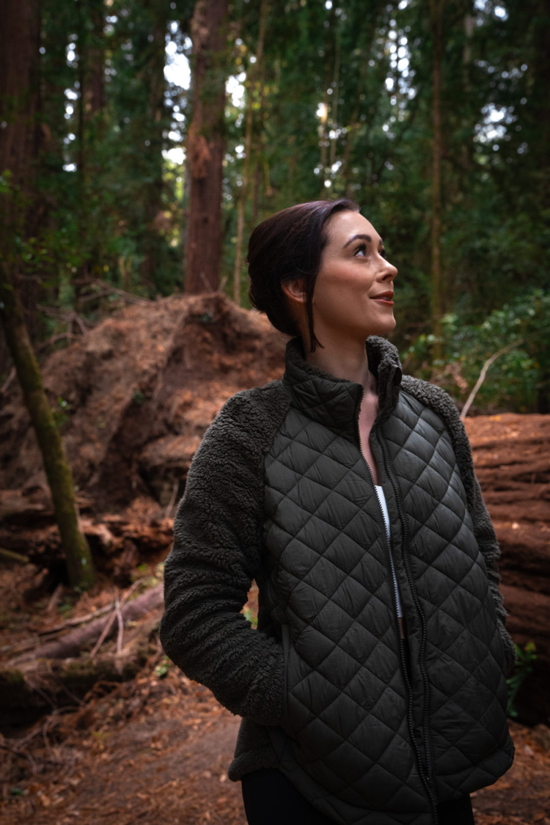 Travel Blogger Jordan Gassner looking up and smiling at the redwoods inside Hendy Woods State Park in Mendocino County