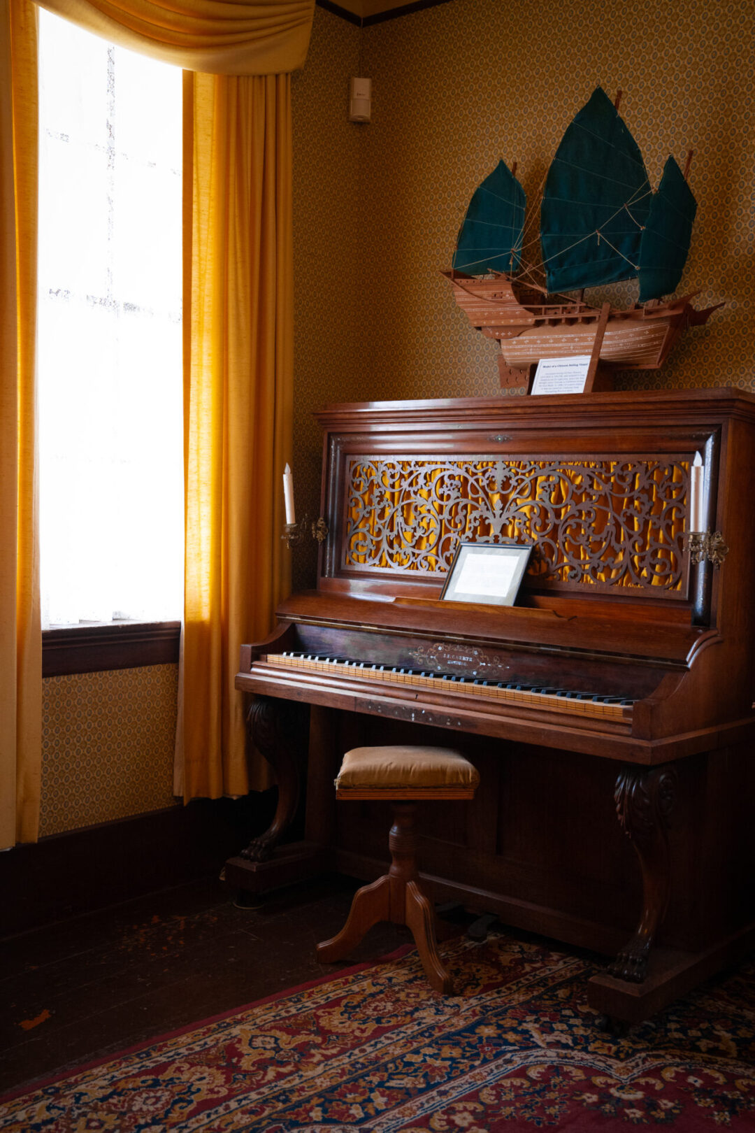 Mendocino Travel Guide: An intricate piano net to a window inside Mendocino's Victorian-era Kelley House Museum