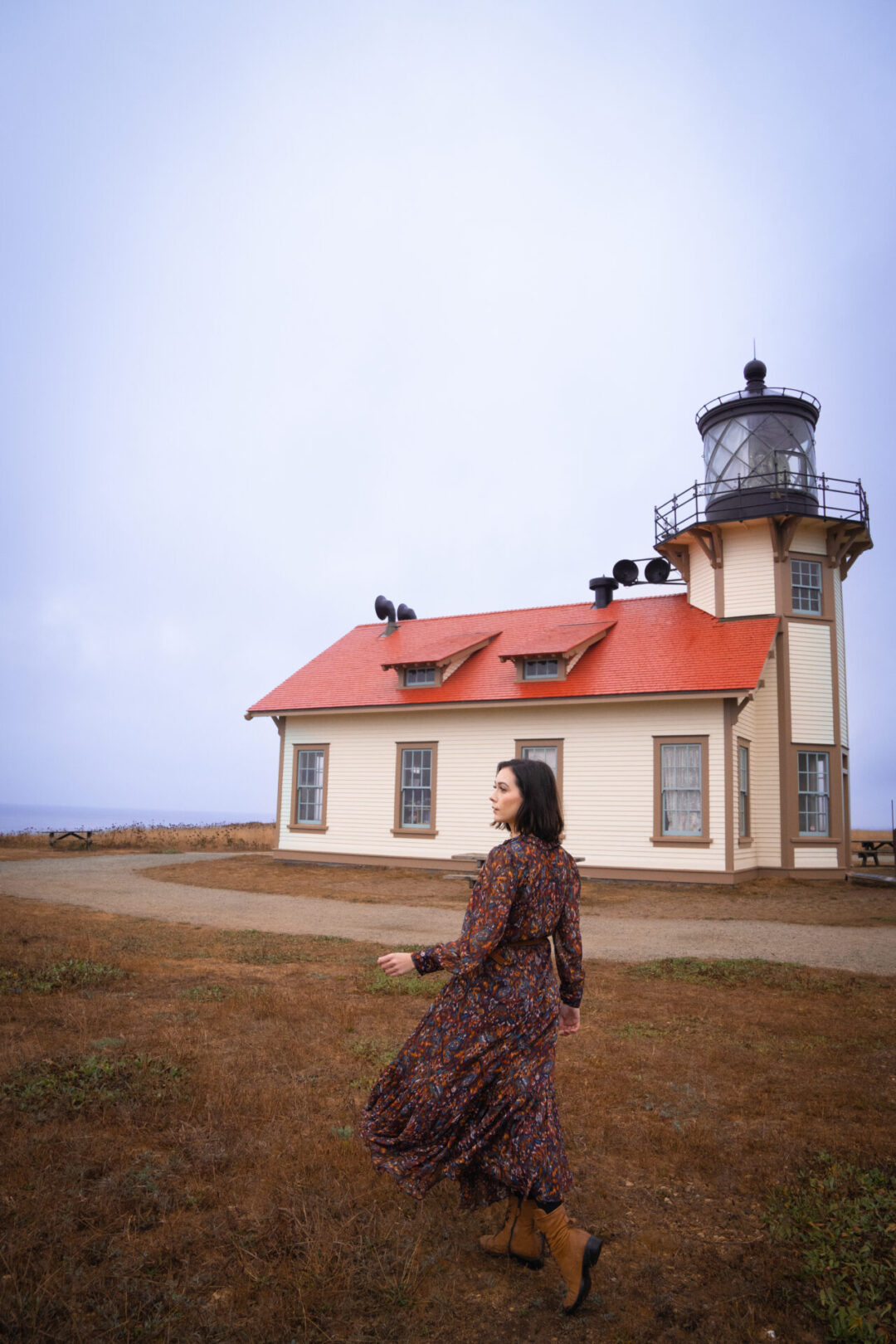 Travel Blogger Jordan Gassner walking toward the Point Cabrillo Lighthouse along the Northern California coast
