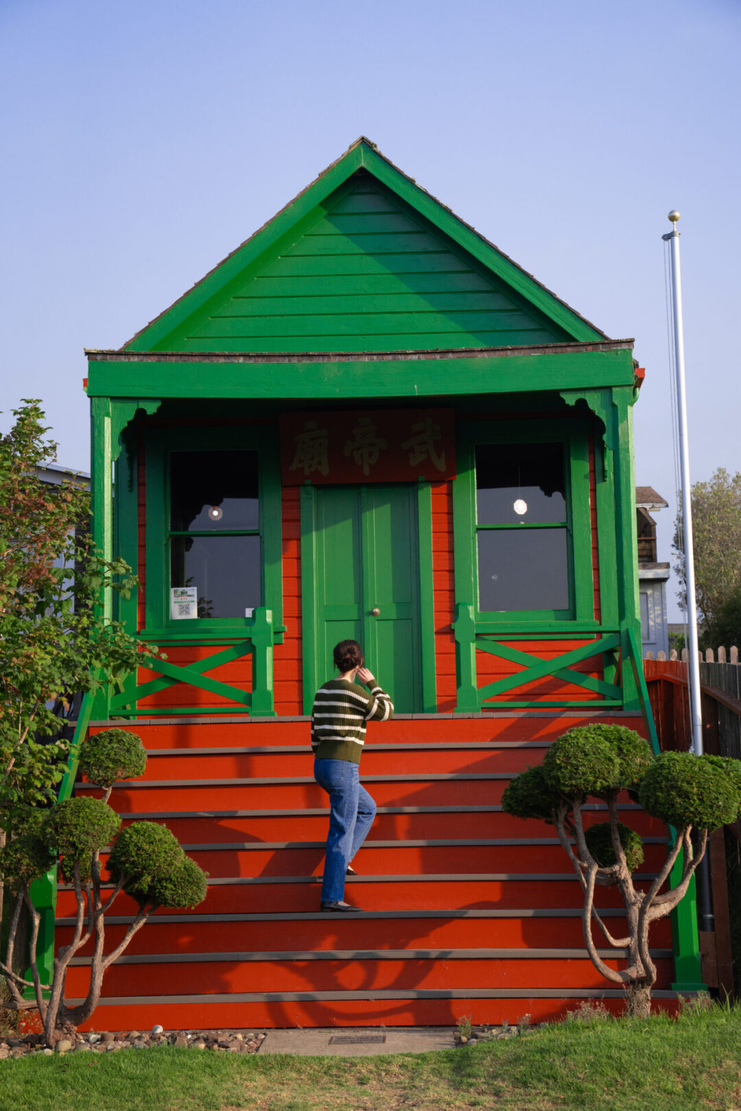 Travel Blogger Jordan Gassner climbing the staircase at Temple of Kwan Tai in Mendocino, California