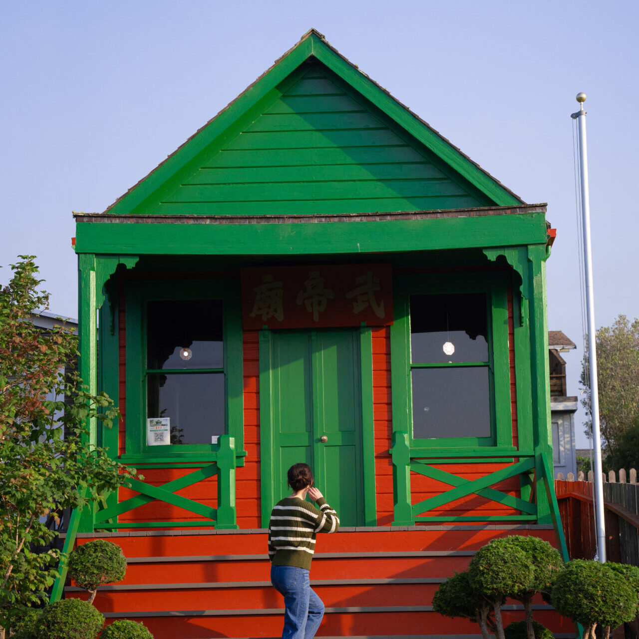 Mendocino Travel Guide: Travel Blogger Jordan Gassner climbing the staircase at Temple of Kwan Tai in Mendocino, California