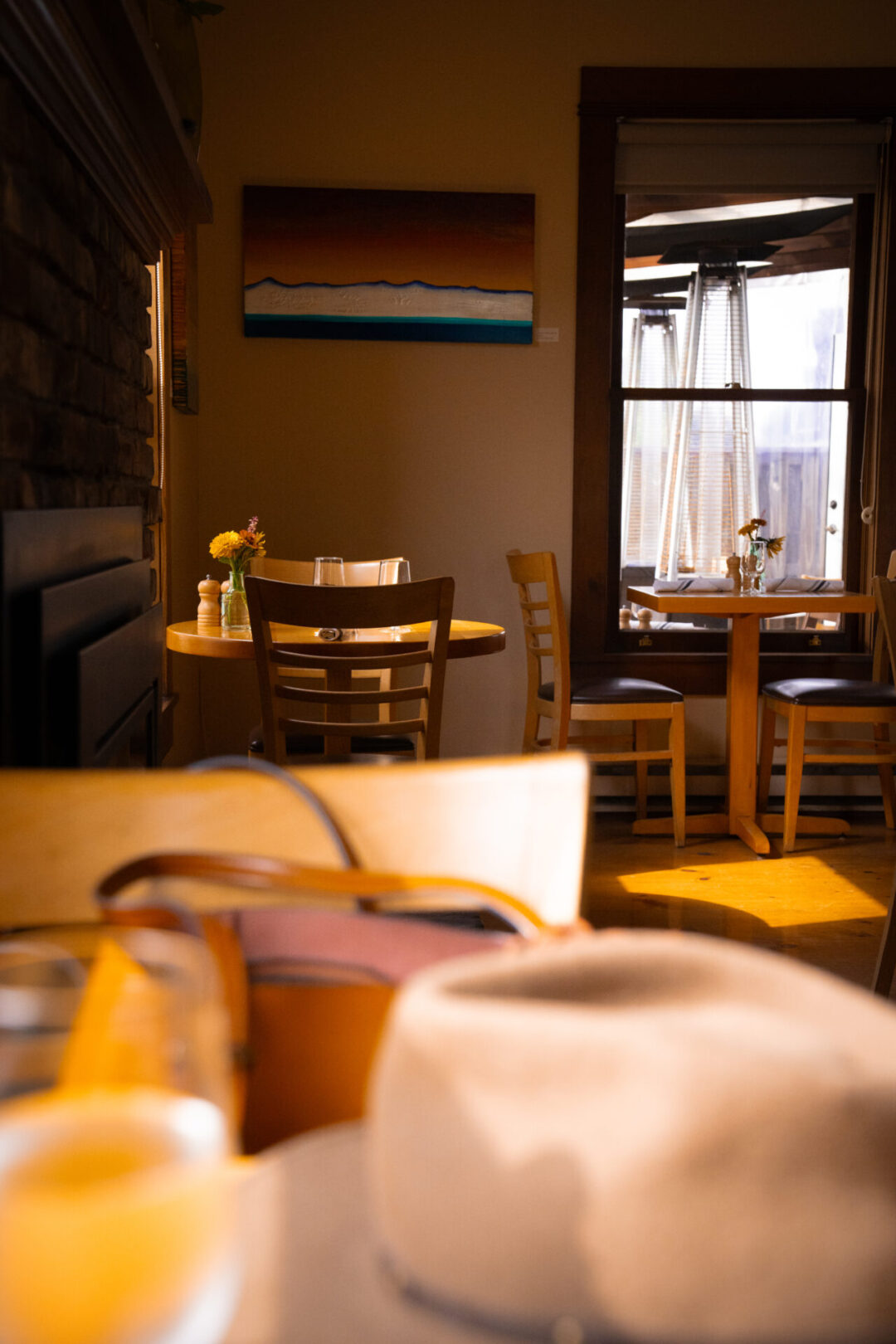 My Second Day in Mendocino: Travel Blogger Jordan Gassner's hat on top of a table inside Trillium Cafe in Mendocino, California