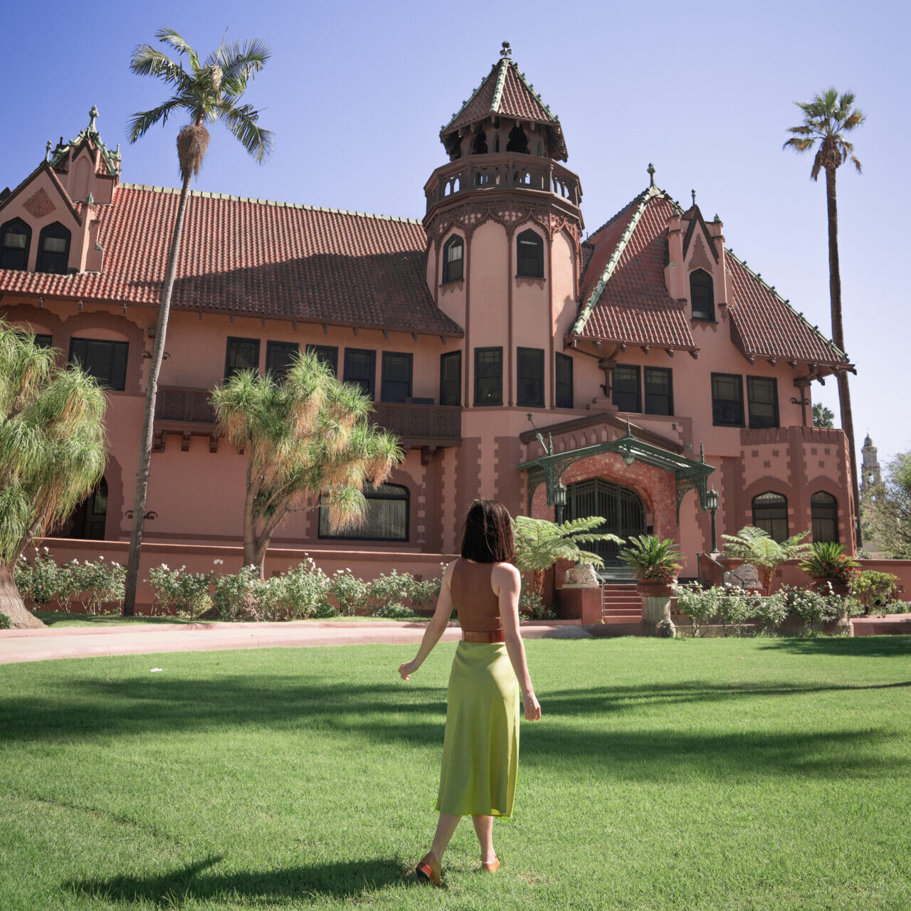 Travel Blogger Jordan Gassner standing on the grass outside of LA's Doheny Mansion, otherwise known as the Genovian Embassy from the Princess Diaries