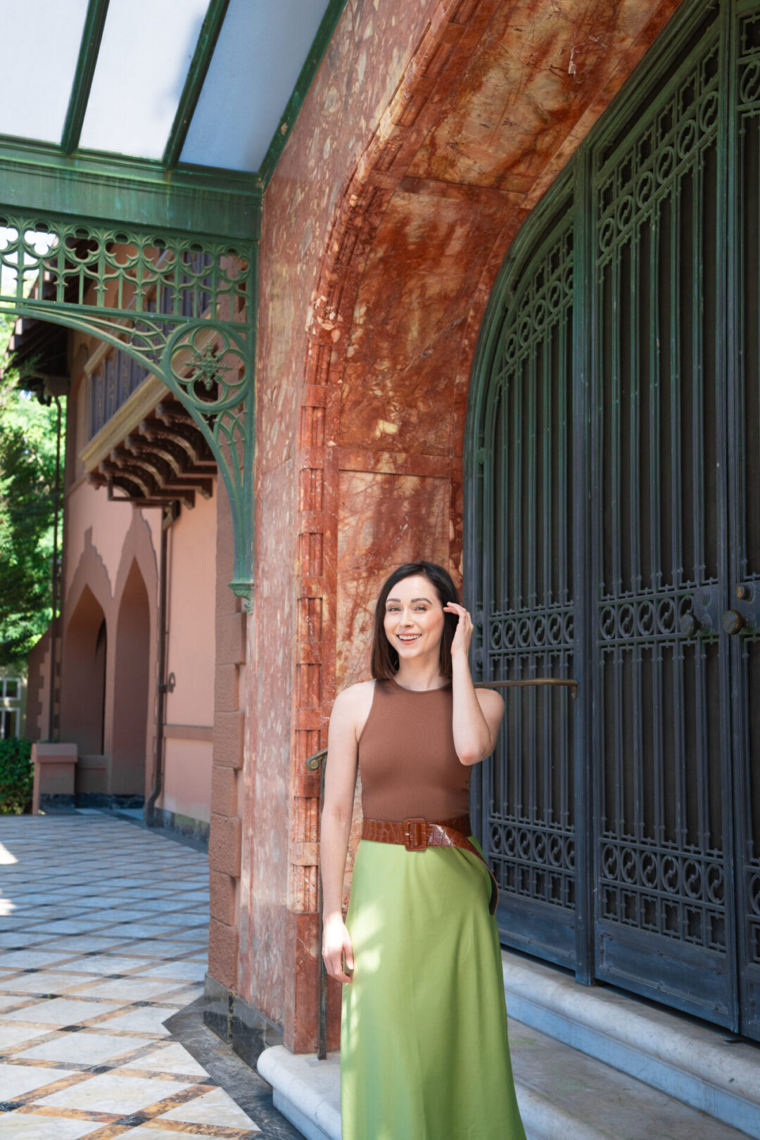 Travel Blogger Jordan Gassner smiling in front of the Doheny Mansion in Los Angeles, California