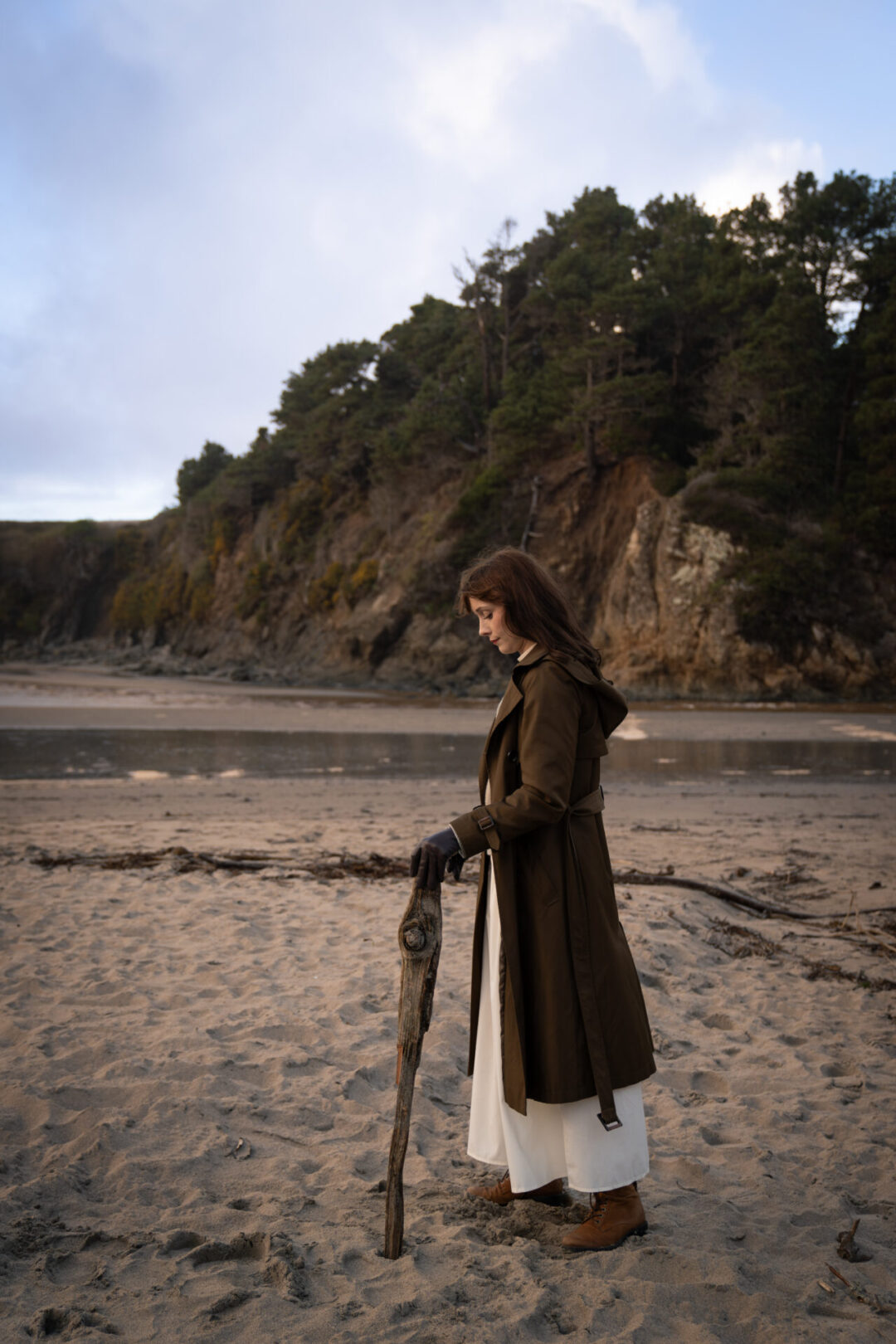 Mendocino Travel Guide: Travel Blogger Jordan Gassner walking with a large stick on the beach at Jug Handle State Reserve in Mendocino, California