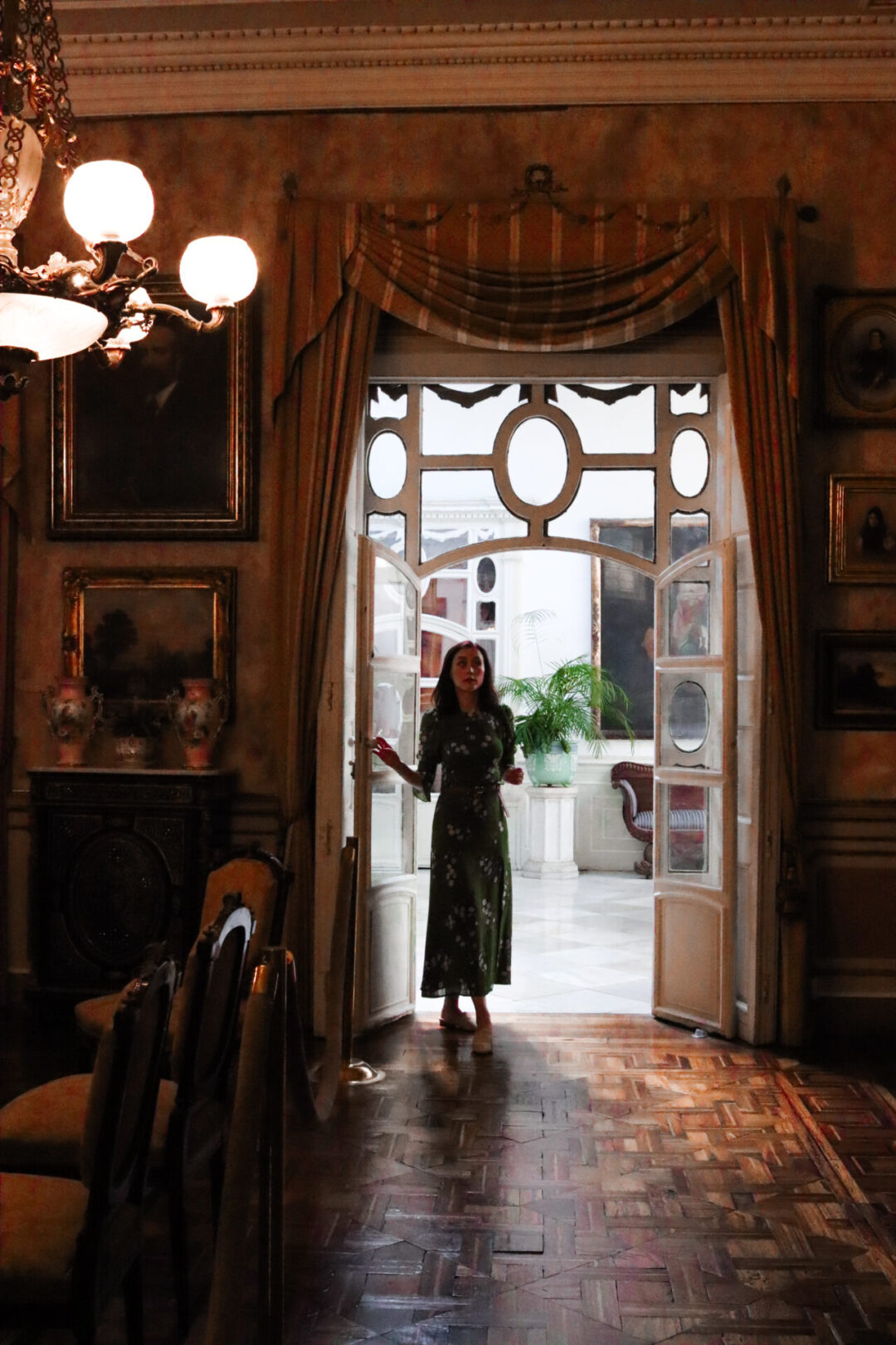 Travel Blogger Jordan Gassner standing in the doorway to the salon inside Casa Aliaga in Lima, Peru