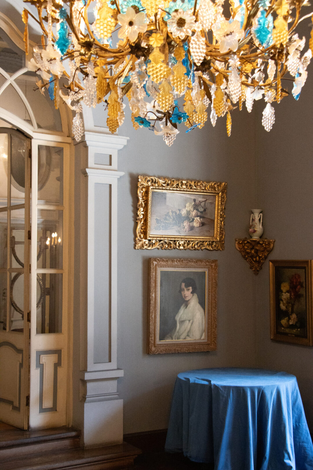 A blue salon with a gold, cream and blue chandelier inside a 19th century salon in Casa de Larriva in Lima, Peru