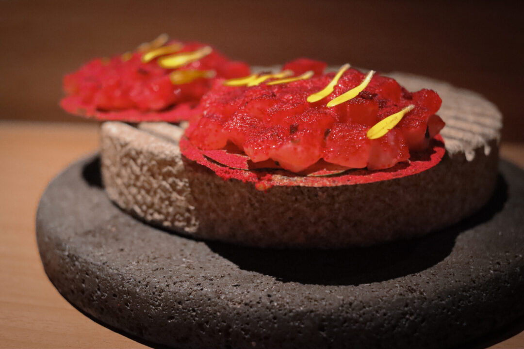 Bright red Tostadas Acevichadas from Merito, a two-story restaurant in Lima, Peru