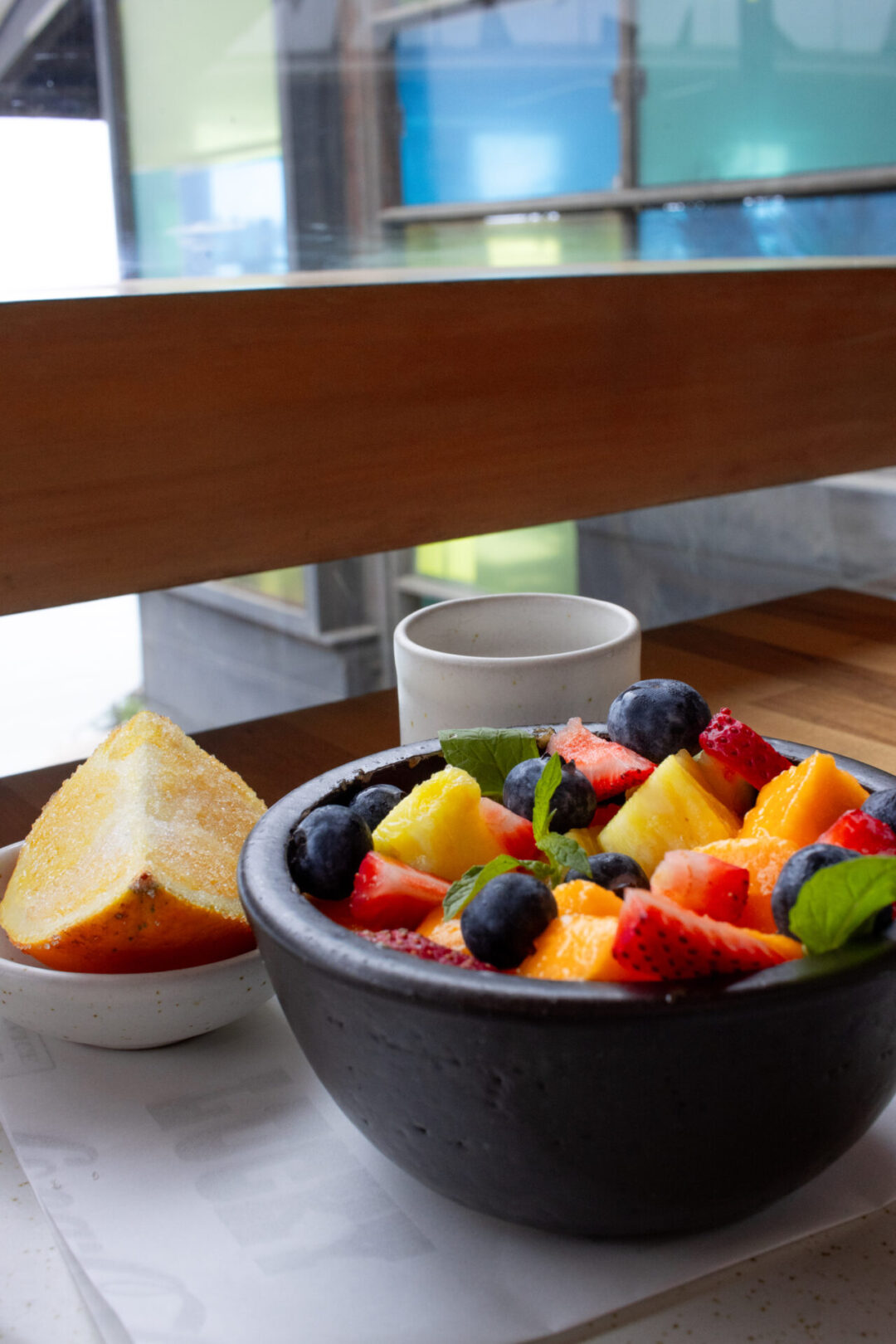 A fruit salad and slice of orange from Popular one of the best Lima restaurants overlooking the Pacific Ocean
