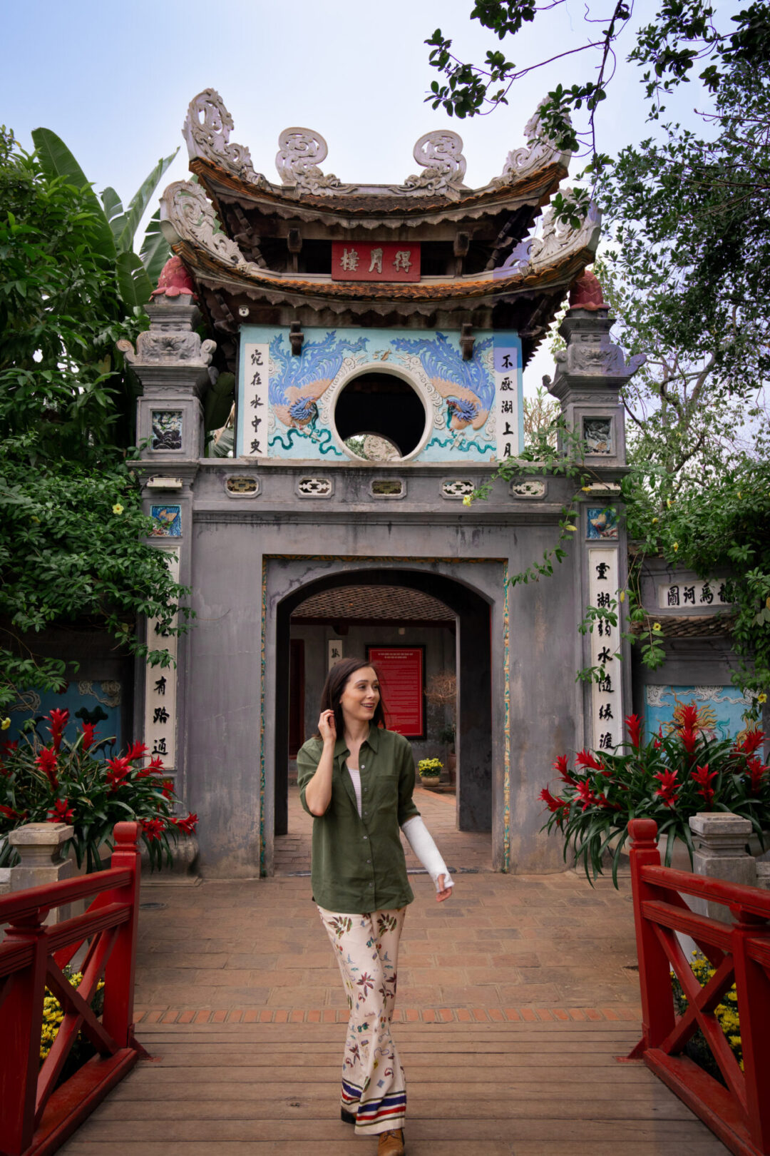 Travel Blogger Jordan Gassner smiling in front of the front of Ngoc Son Pagoda in Hanoi, Vietnam