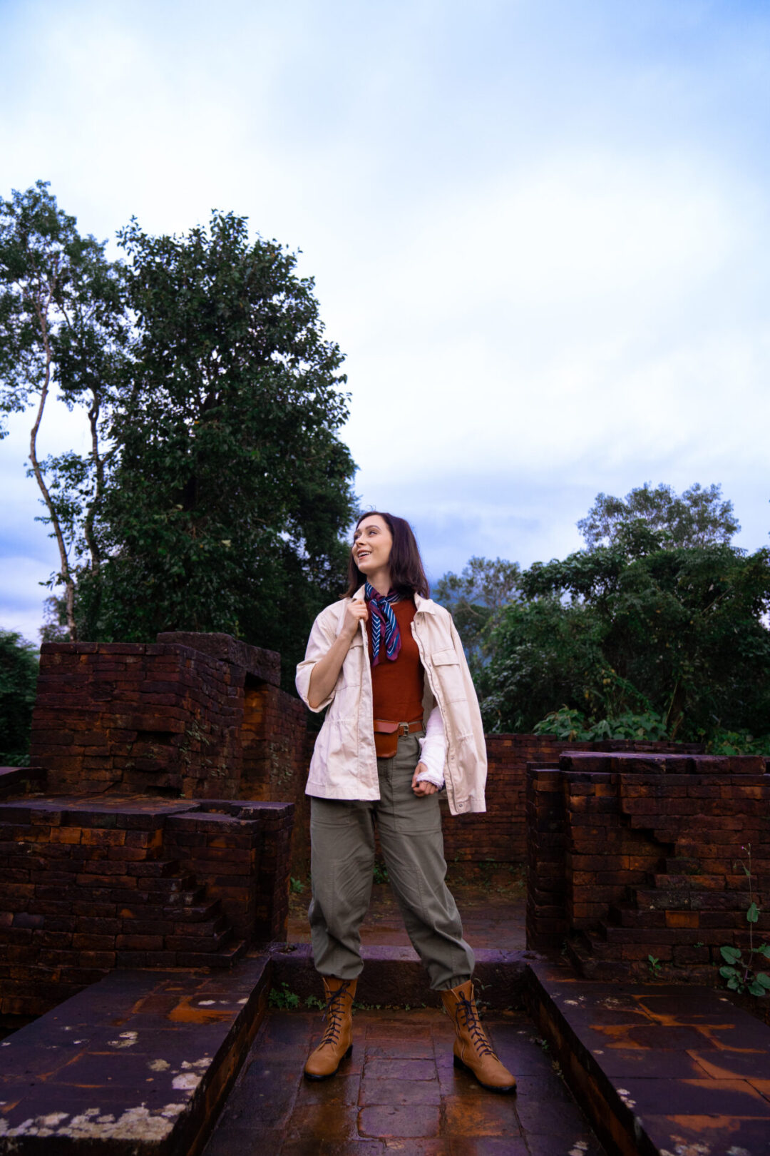 What to Pack For Vietnam: Travel Blogger Jordan Gassner standing atop some of the ancient ruins at MySon near Hoi An while adventuring in Vietnam