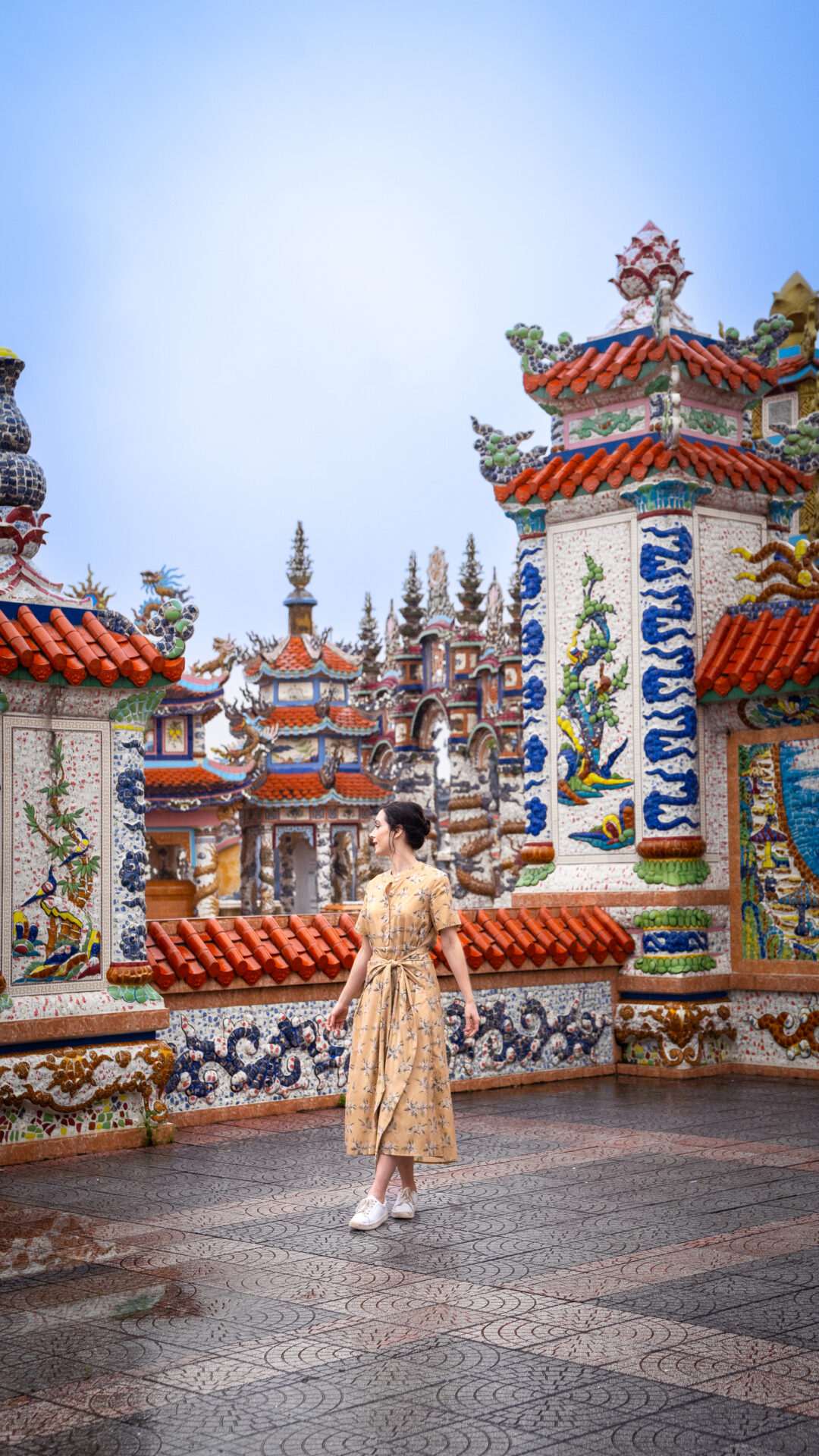 Travel Blogger Jordan Gassner looking over her shoulder inside An Bang Cemetery City of Ghosts in Hue, Vietnam