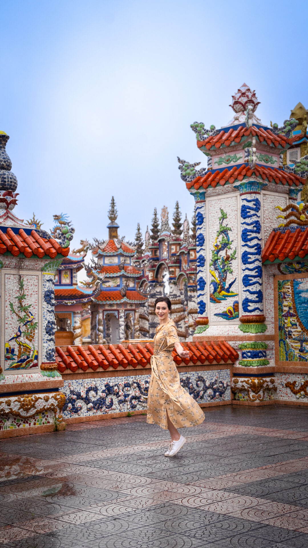 Travel Blogger Jordan Gassner twirling at An Bang Cemetery City of Ghosts in Hue, Vietnam