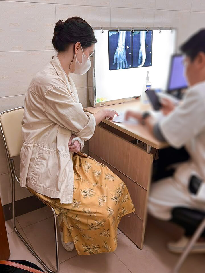 Travel Blogger Jordan Gassner going over her x-rays with a doctor in Vietnam
