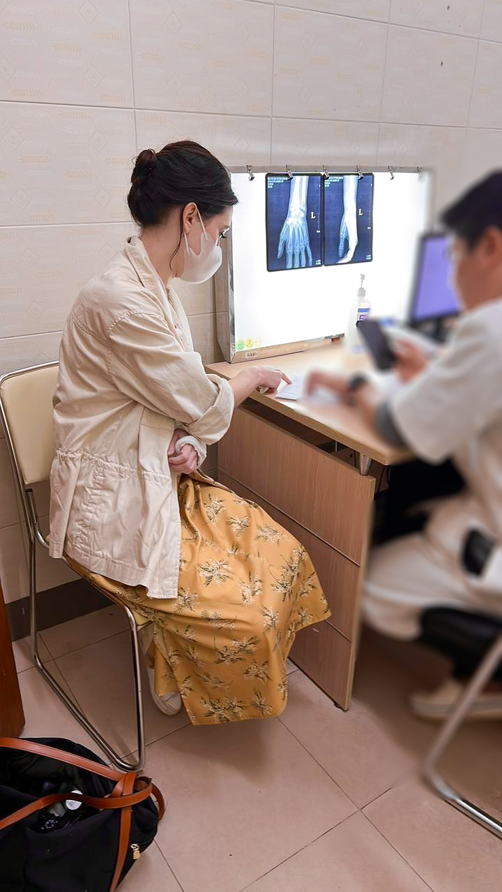 Travel Blogger Jordan Gassner going over her x-rays with a doctor in Vietnam