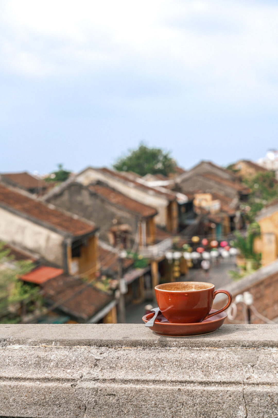 Things to do in Hoi An: Drink Vietnamese coffee from a mug on top a roof in Hoi An, Vietnam
