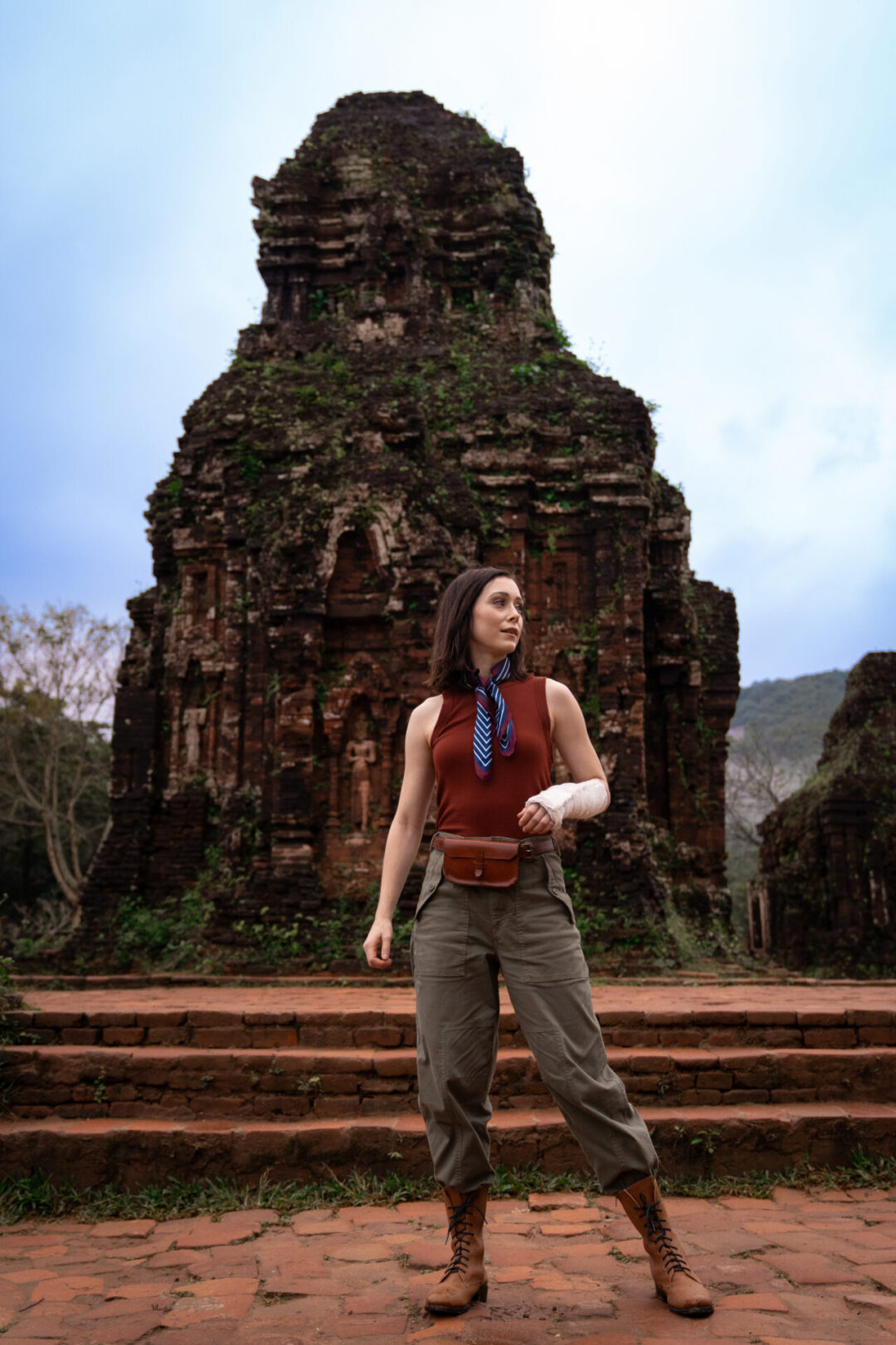 Travel Blogger Jordan Gassner standing in front of a stone tower built by the Cham people at My Son Sanctuary near Hoi An, Vietnam