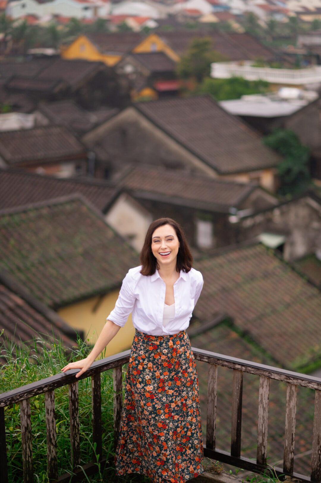 Travel Blogger Jordan Gassner laughing from a rooftop in Old Town Hoi An, Vietnam