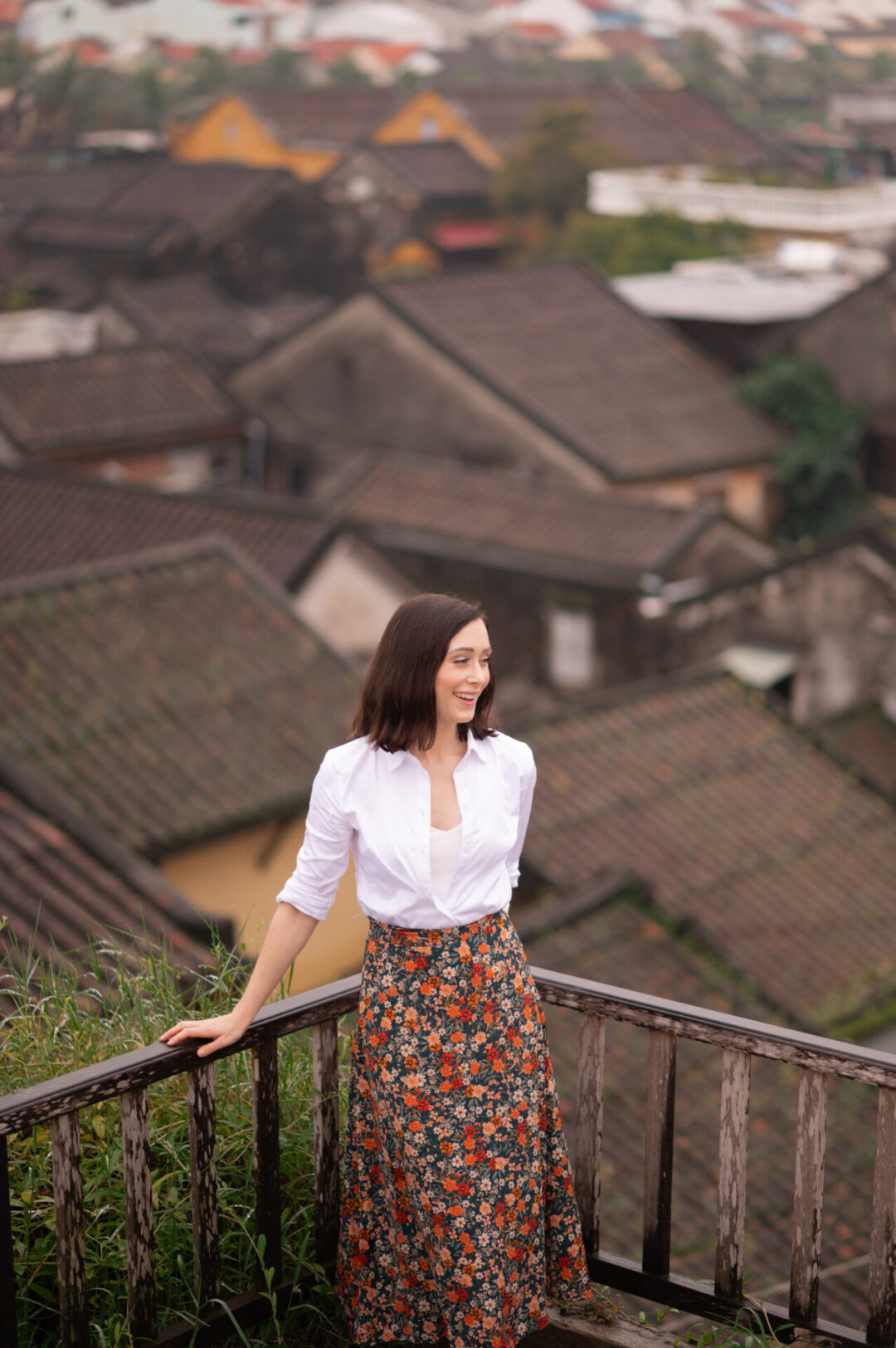 Travel Blogger Jordan Gassner smiling from a rooftop in Old Town Hoi An, Vietnam