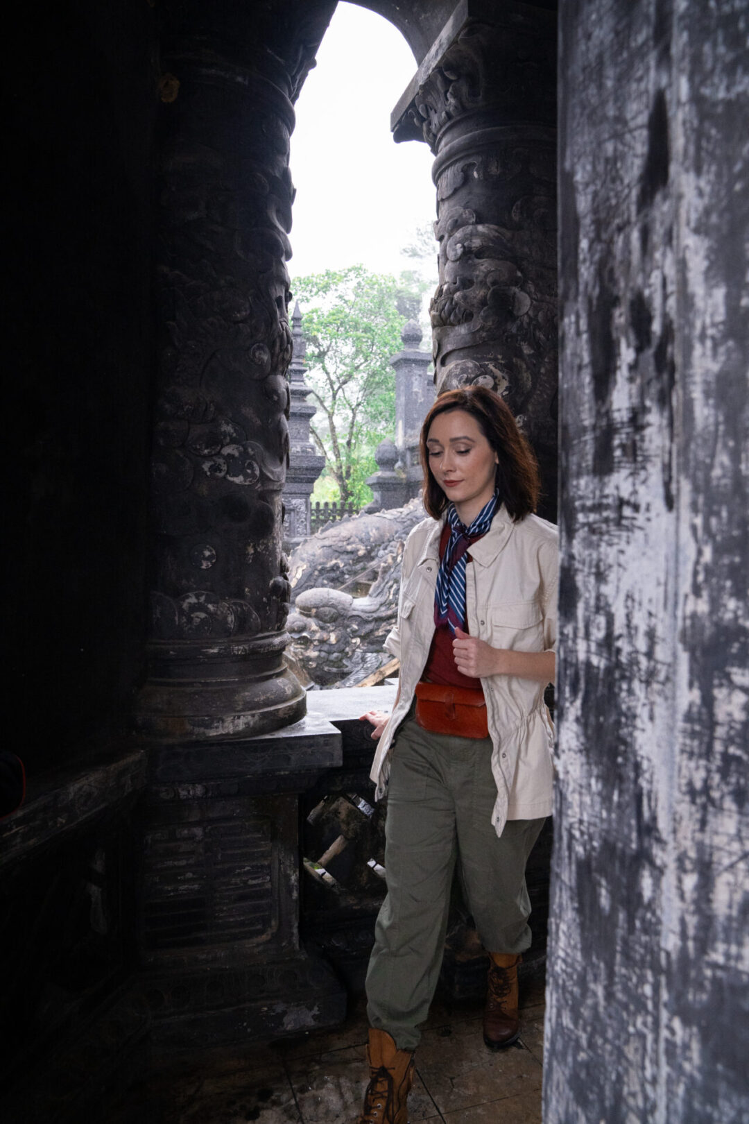 Travel Blogger Jordan Gassner walking through one of the outdoor pavillions at the Tomb of Khai Dinh in Hue, Vietnam