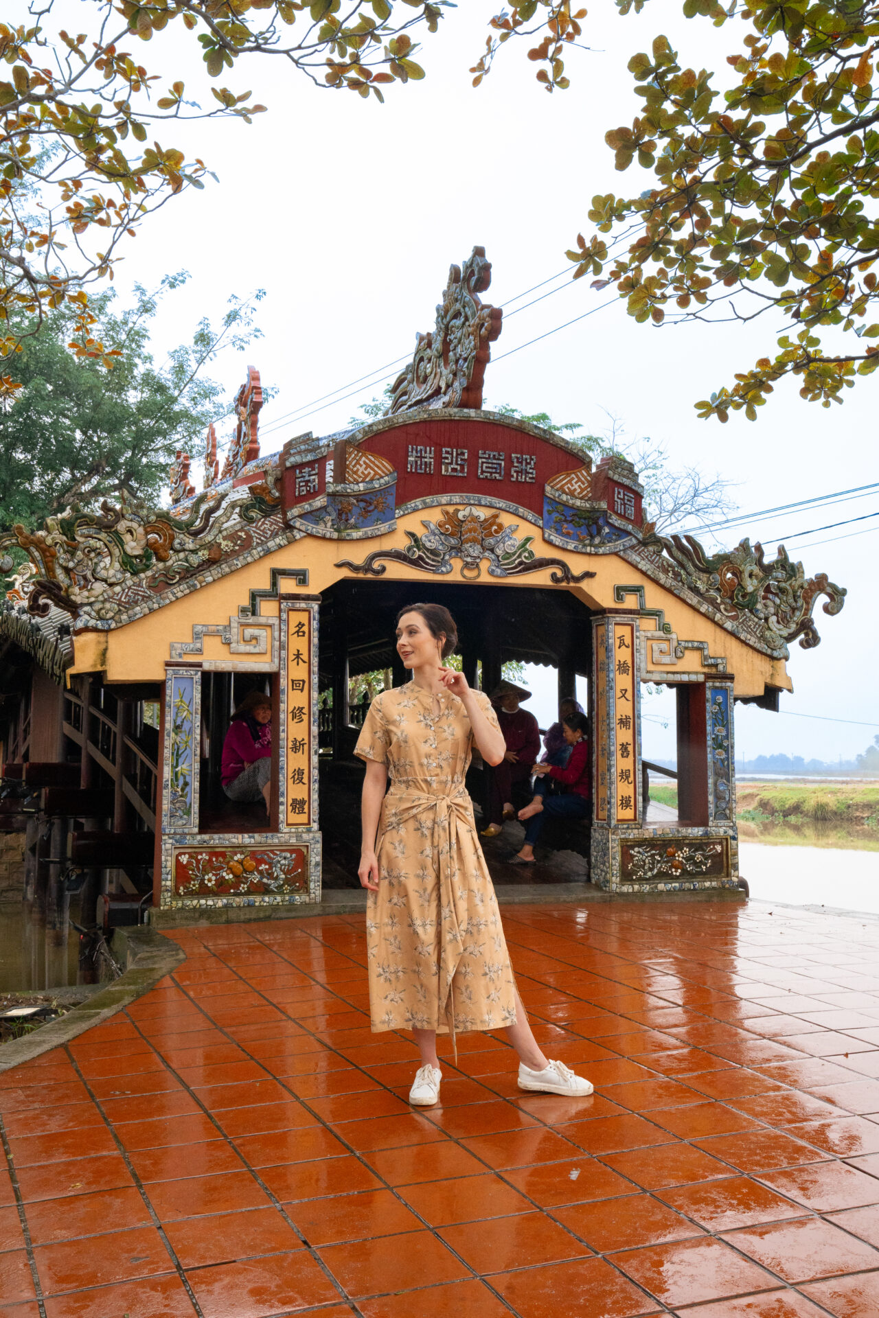 Travel Blogger Jordan Gassner smiling in front of Thanh Toan Bridge in Hue, Vietnam